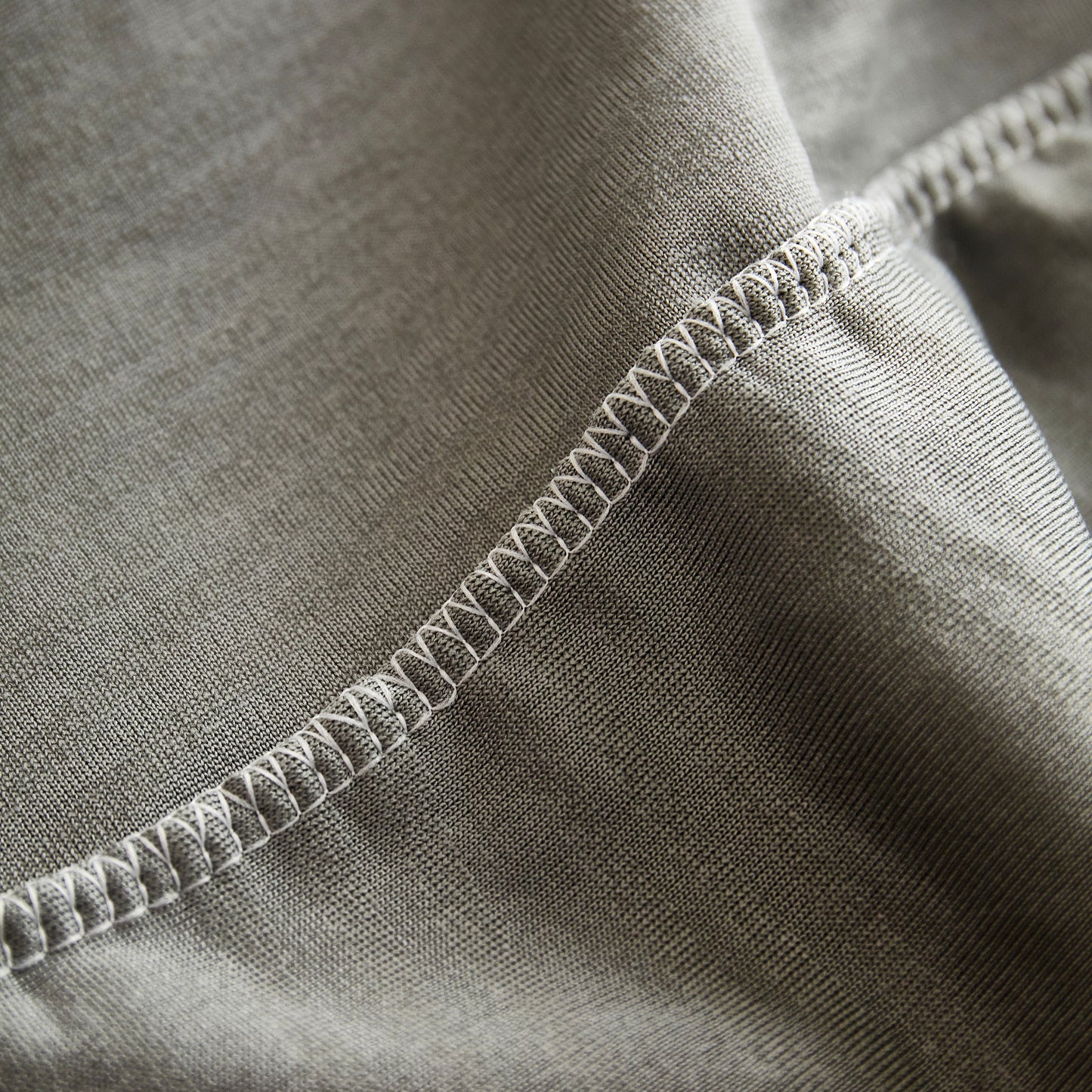 Close-up of Textured Wave Stretch Sofa Couch Cover, soft washable spandex furniture slipcovers with elegant wave pattern and stitching detail