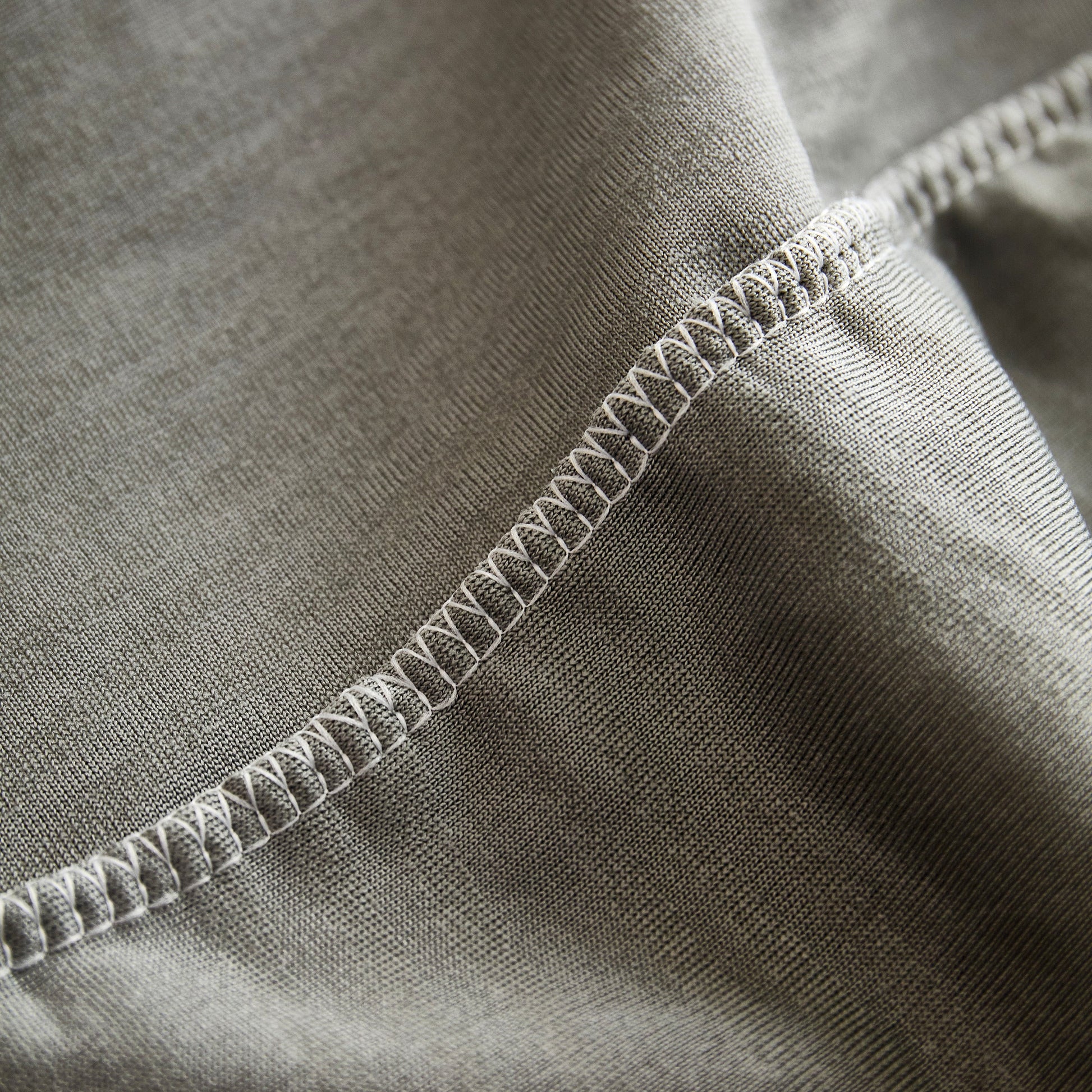 Close-up of Textured Wave Stretch Sofa Couch Cover, soft washable spandex furniture slipcovers with elegant wave pattern and stitching detail