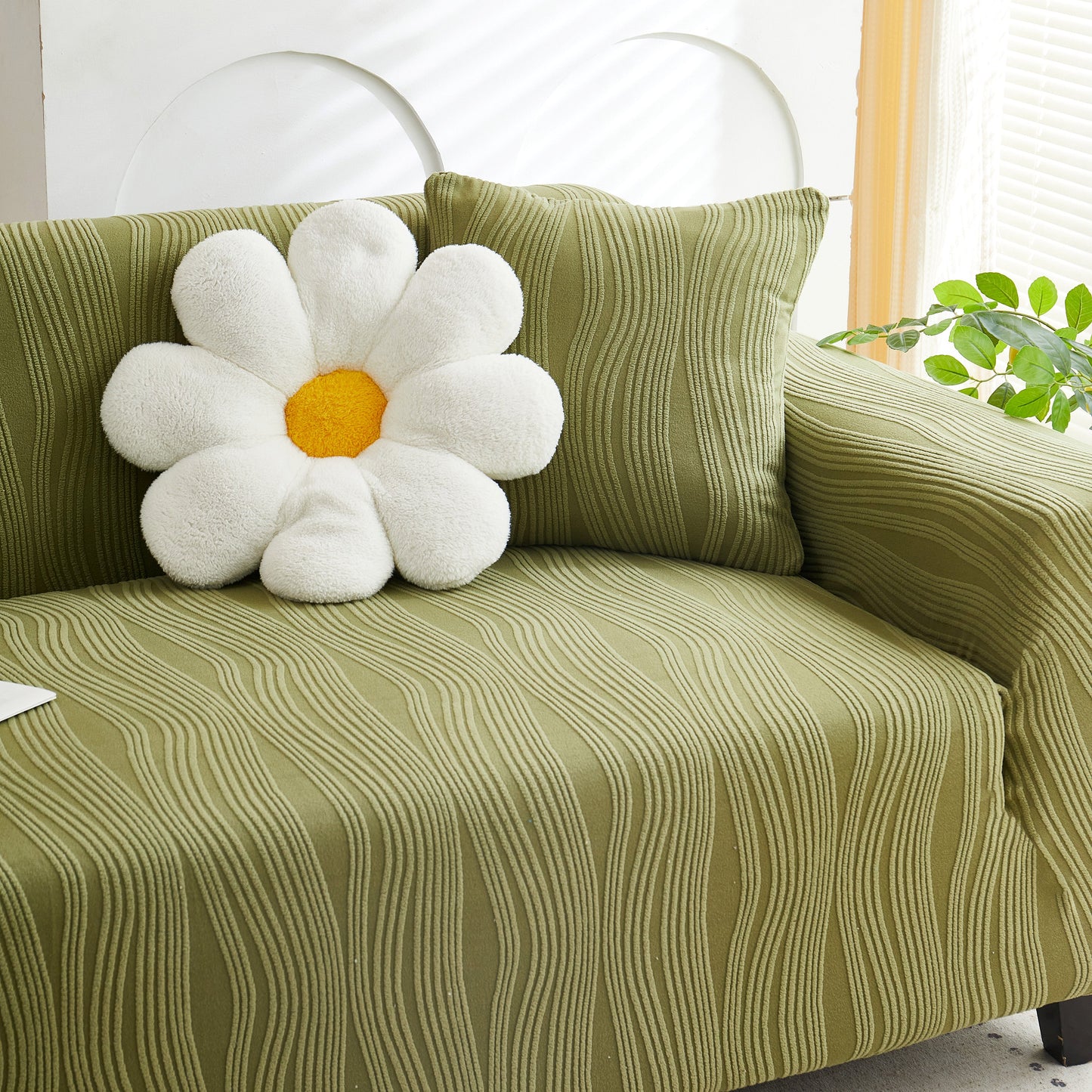 Textured Wave Stretch Sofa Couch Cover on green sofa with soft washable spandex slipcovers, featuring elegant wave pattern and flower cushion.