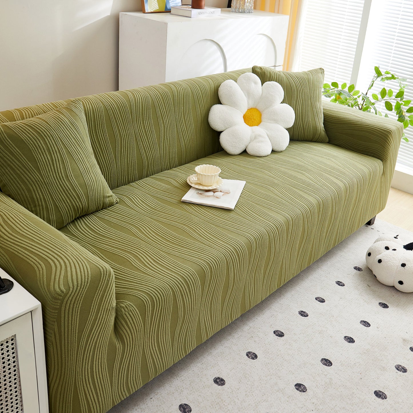 Olive sofa with Textured Wave Stretch Sofa Couch Cover, featuring a daisy pillow, showcasing soft washable spandex furniture slipcovers.