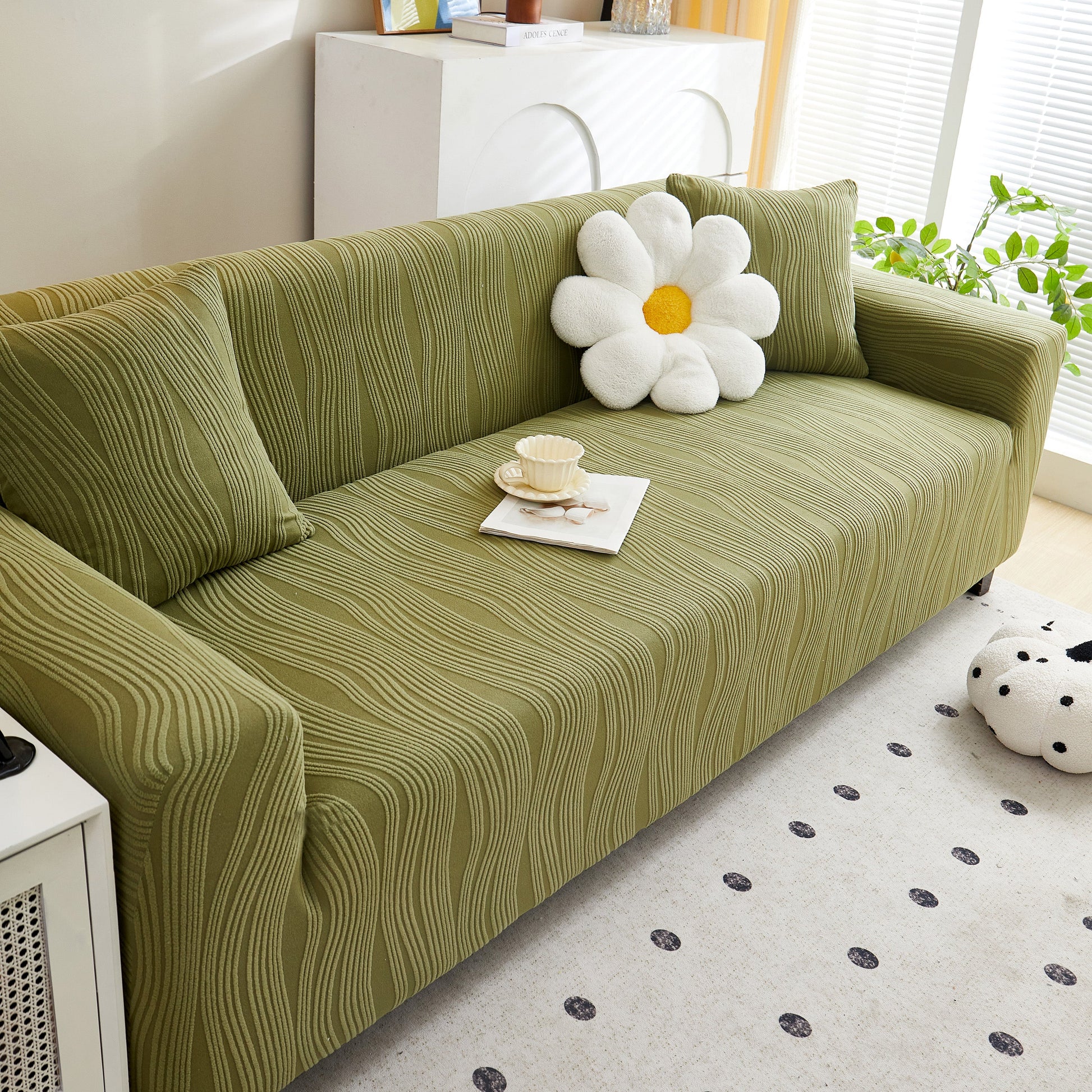 Olive sofa with Textured Wave Stretch Sofa Couch Cover, featuring a daisy pillow, showcasing soft washable spandex furniture slipcovers.