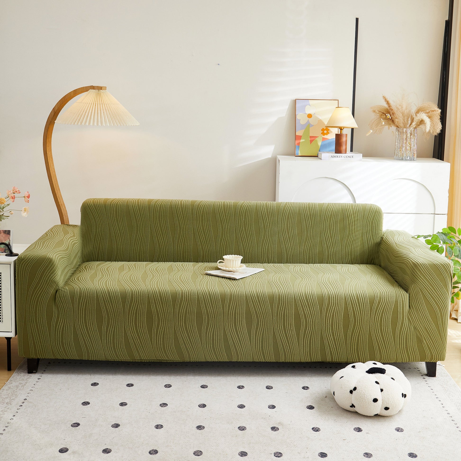 Bright living room showcasing a green Textured Wave Stretch Sofa Couch Cover, Soft Washable Spandex Furniture Slipcovers for a stylish look.