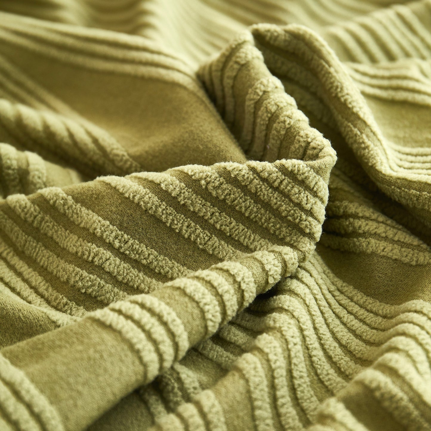 Close-up of Textured Wave Stretch Sofa Couch Cover, soft washable spandex furniture slipcovers with elegant wave pattern, green color.