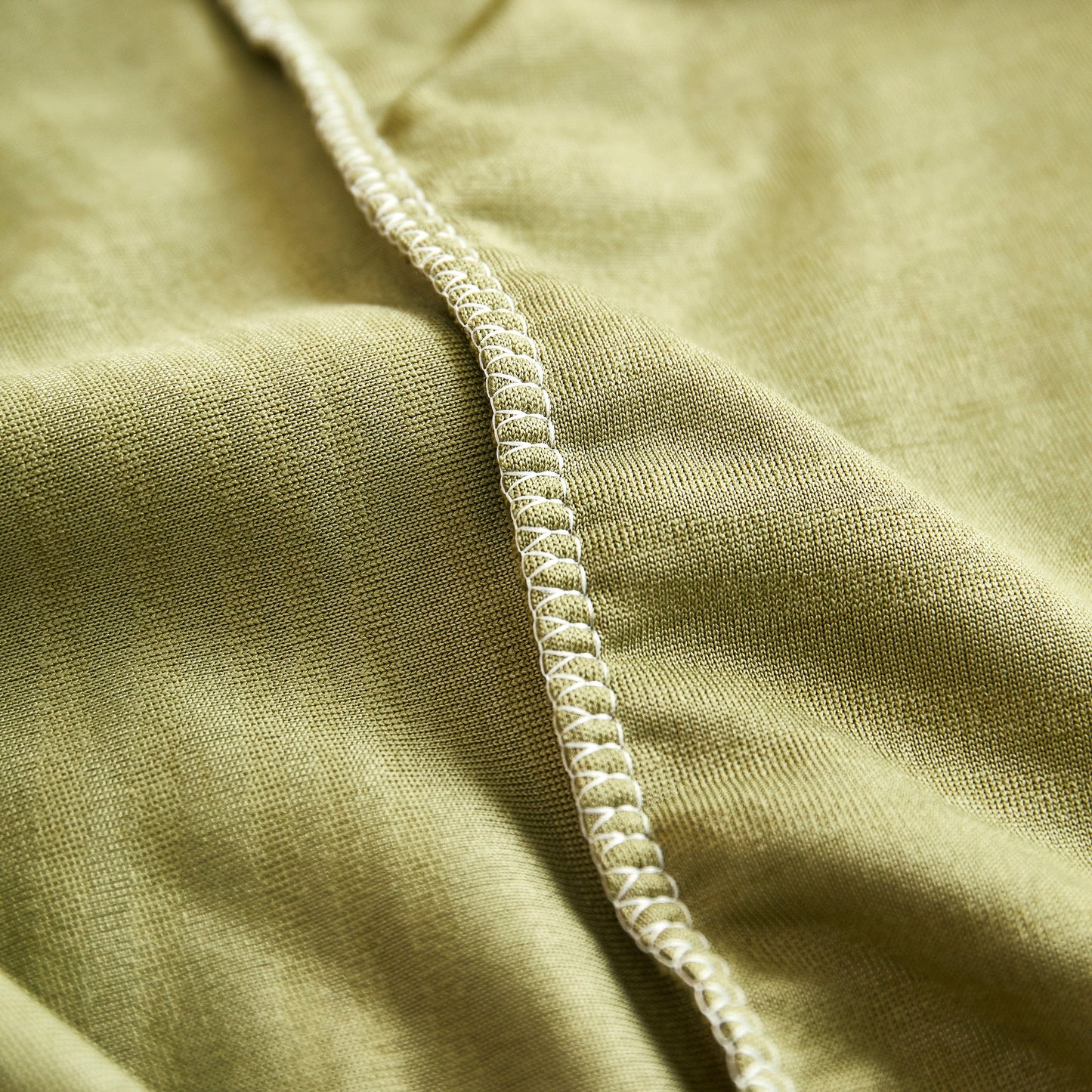 Close-up of soft, stretchy spandex in green Textured Wave Stretch Sofa Couch Cover, Soft Washable Spandex Furniture Slipcovers.
