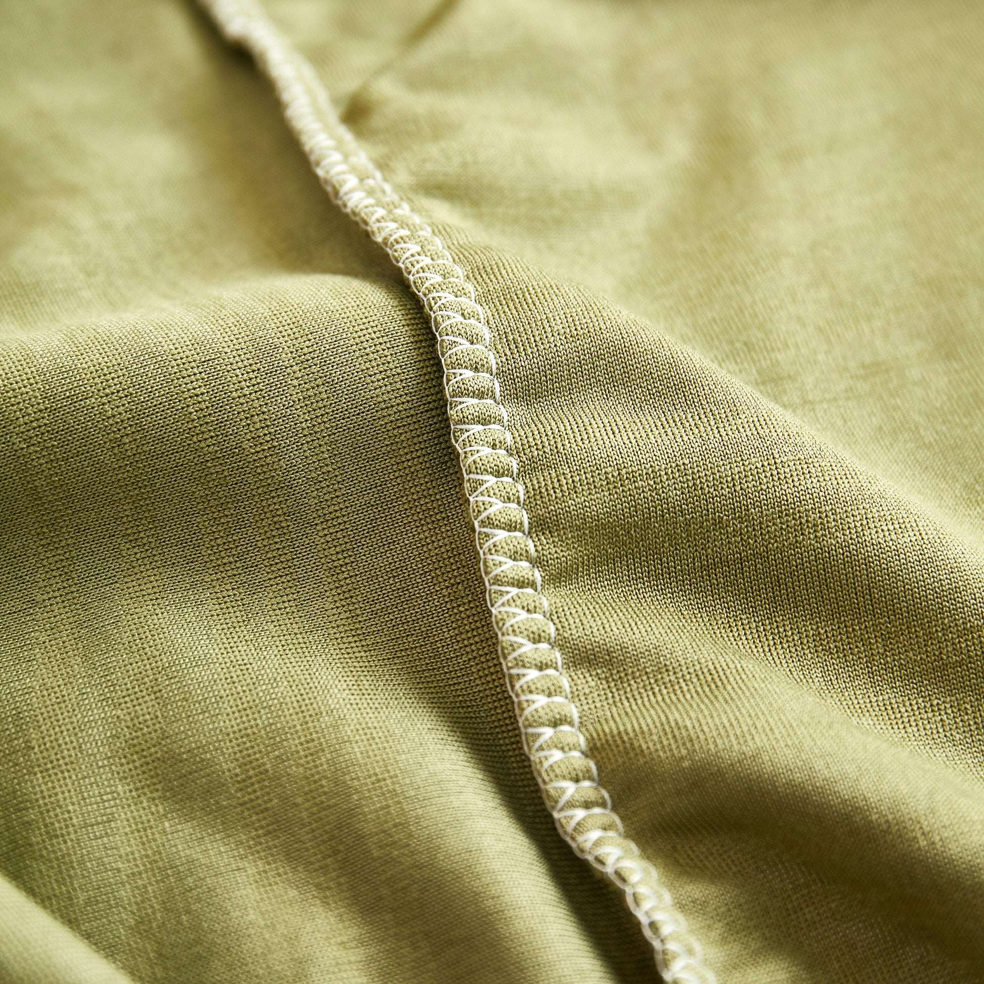 Close-up of soft, stretchy spandex in green Textured Wave Stretch Sofa Couch Cover, Soft Washable Spandex Furniture Slipcovers.
