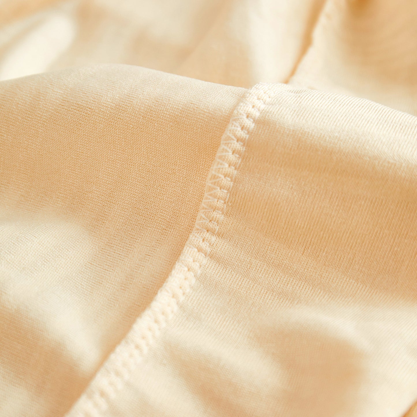 Close-up of Textured Wave Stretch Sofa Couch Cover showcasing the soft, washable spandex fabric and elegant design.