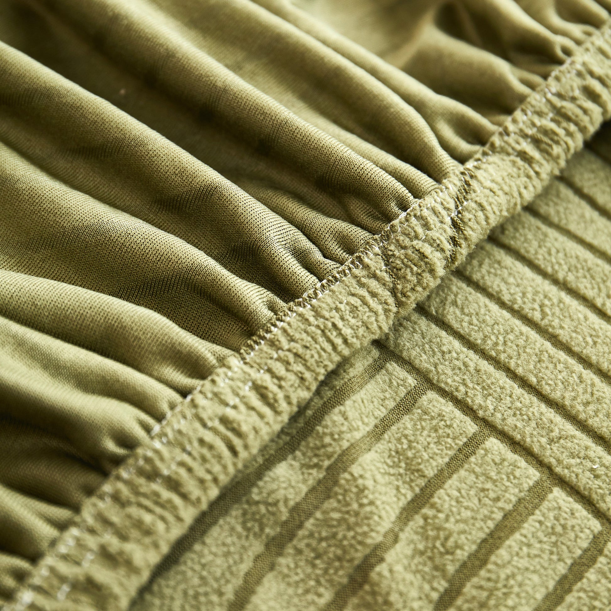 Close-up of Fleece Stretch Sofa Slipcover Washable Soft Spandex Couch Cover Furniture Protector showing elastic edge and fabric texture.