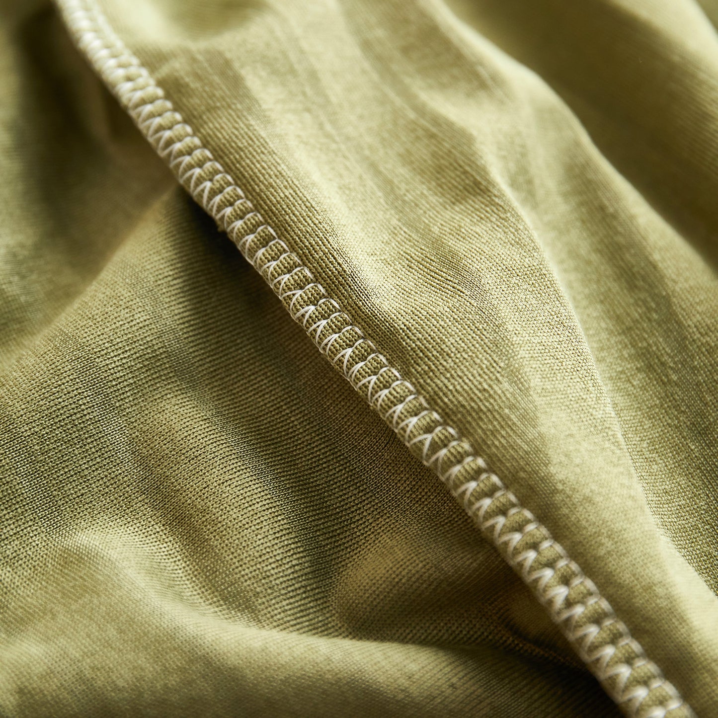 Close-up of Fleece Stretch Sofa Slipcover Washable Soft Spandex Couch Cover Furniture Protector with textured wave pattern.