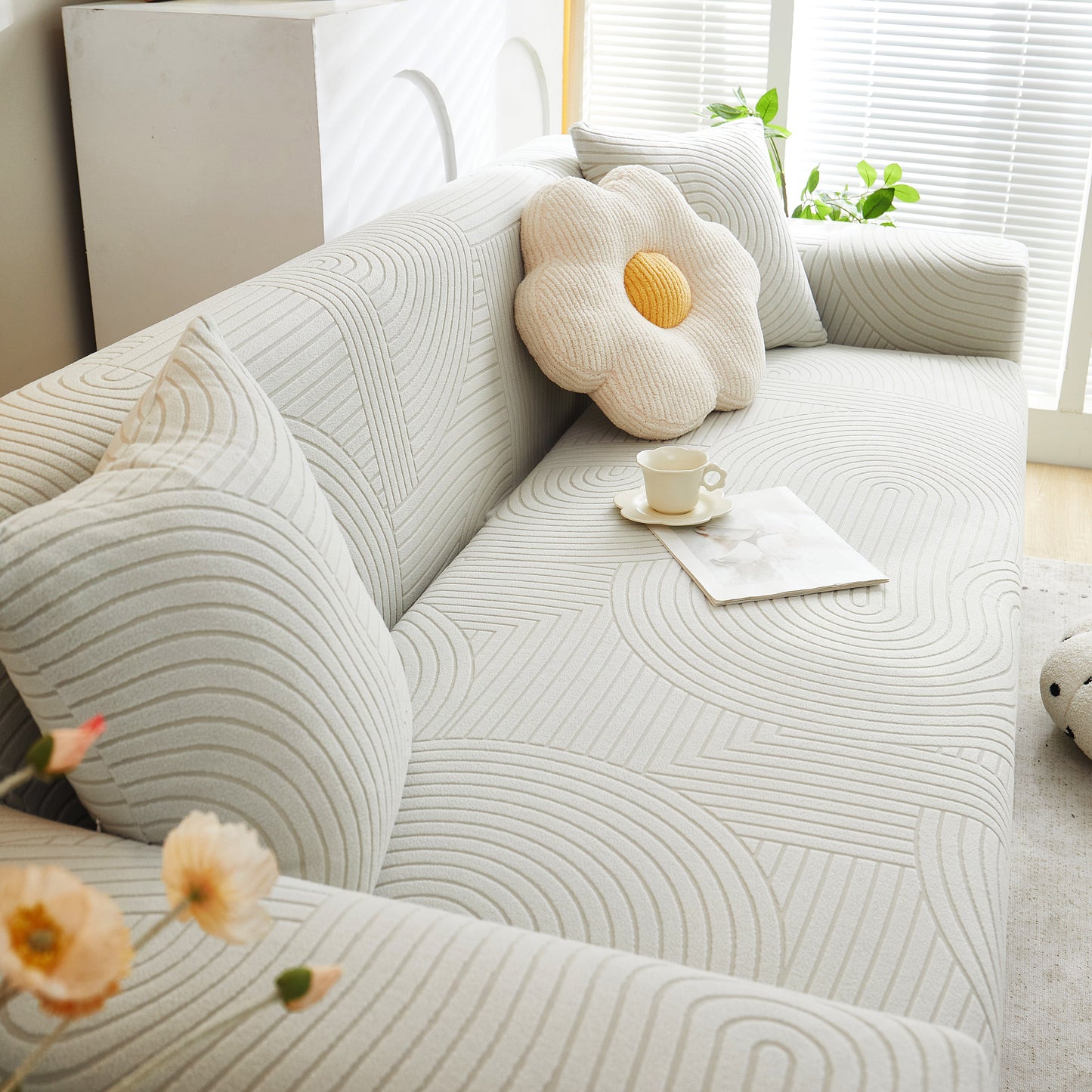 White sofa with Fleece Stretch Sofa Slipcover Washable Soft Spandex Couch Cover, featuring geometric wave pattern.