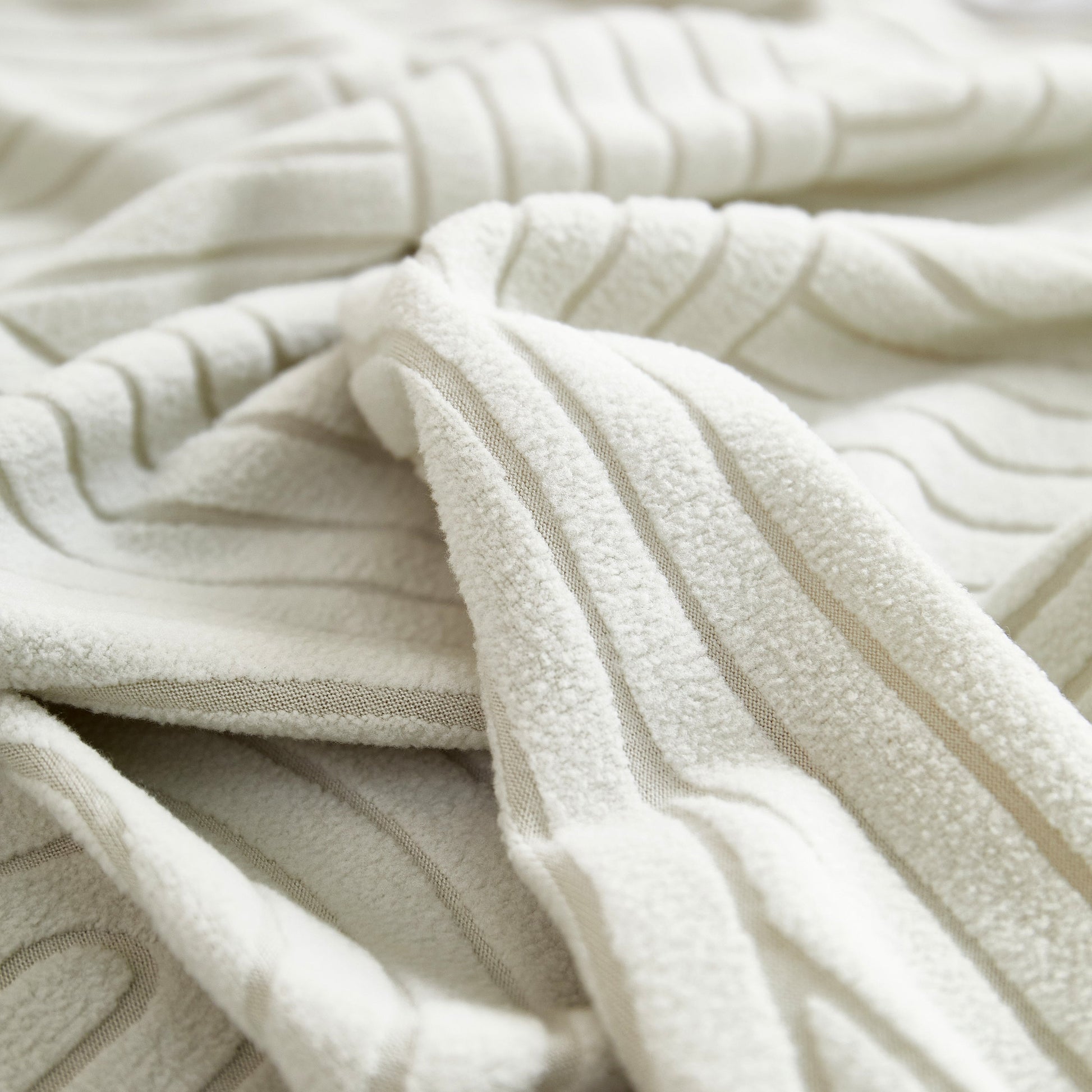 Close-up of Fleece Stretch Sofa Slipcover Washable Soft Spandex Couch Cover Furniture Protector with geometric wave pattern.