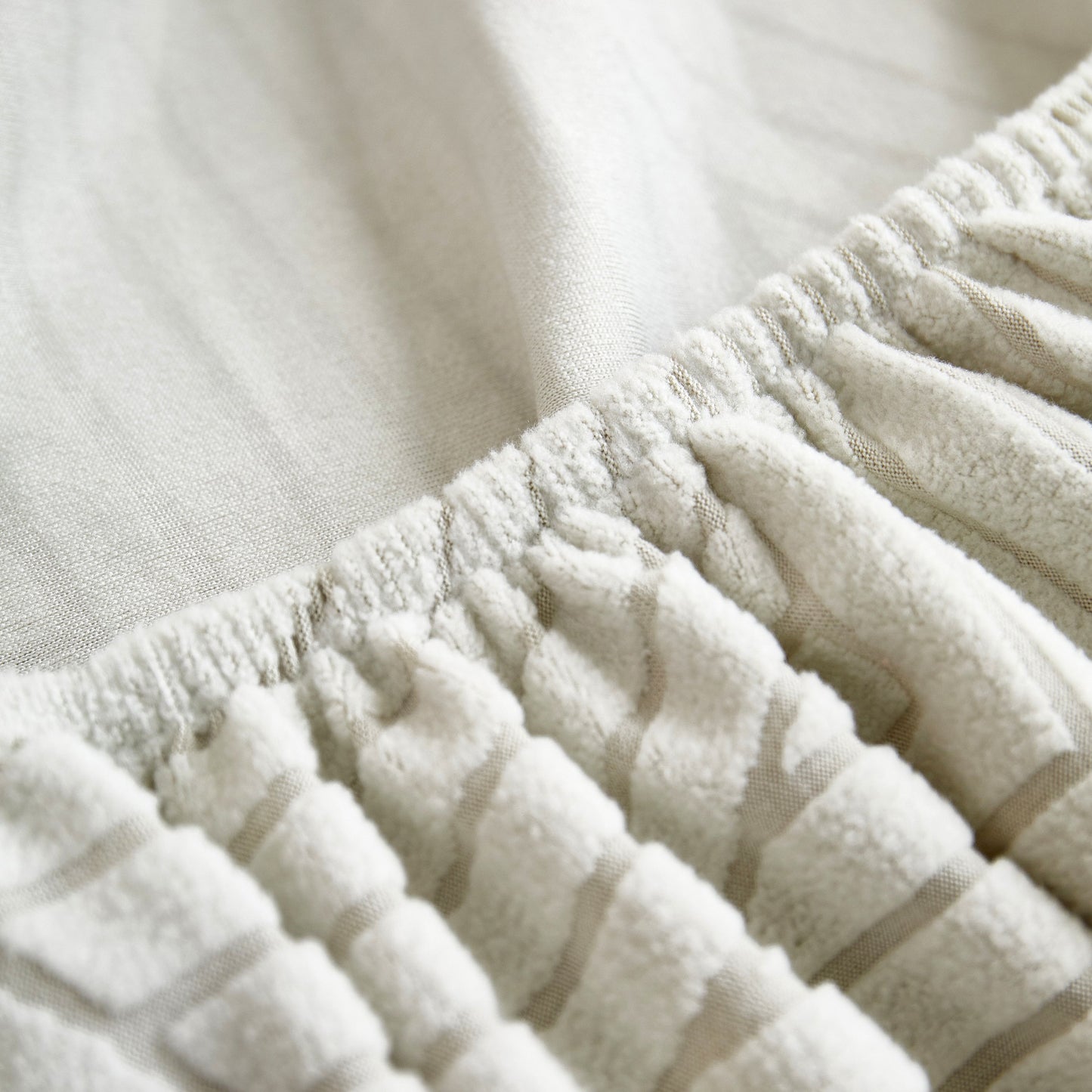 Close-up of Fleece Stretch Sofa Slipcover Washable Soft Spandex Couch Cover Furniture Protector showing elastic texture
