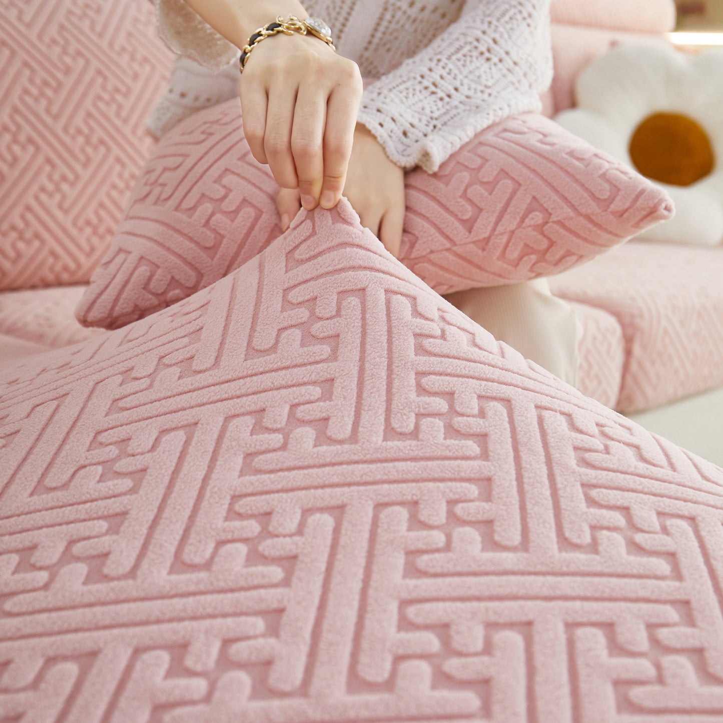 Polar Fleece Couch Cushion Covers in pink, showcasing the fabric detail and stretchability on a sofa.