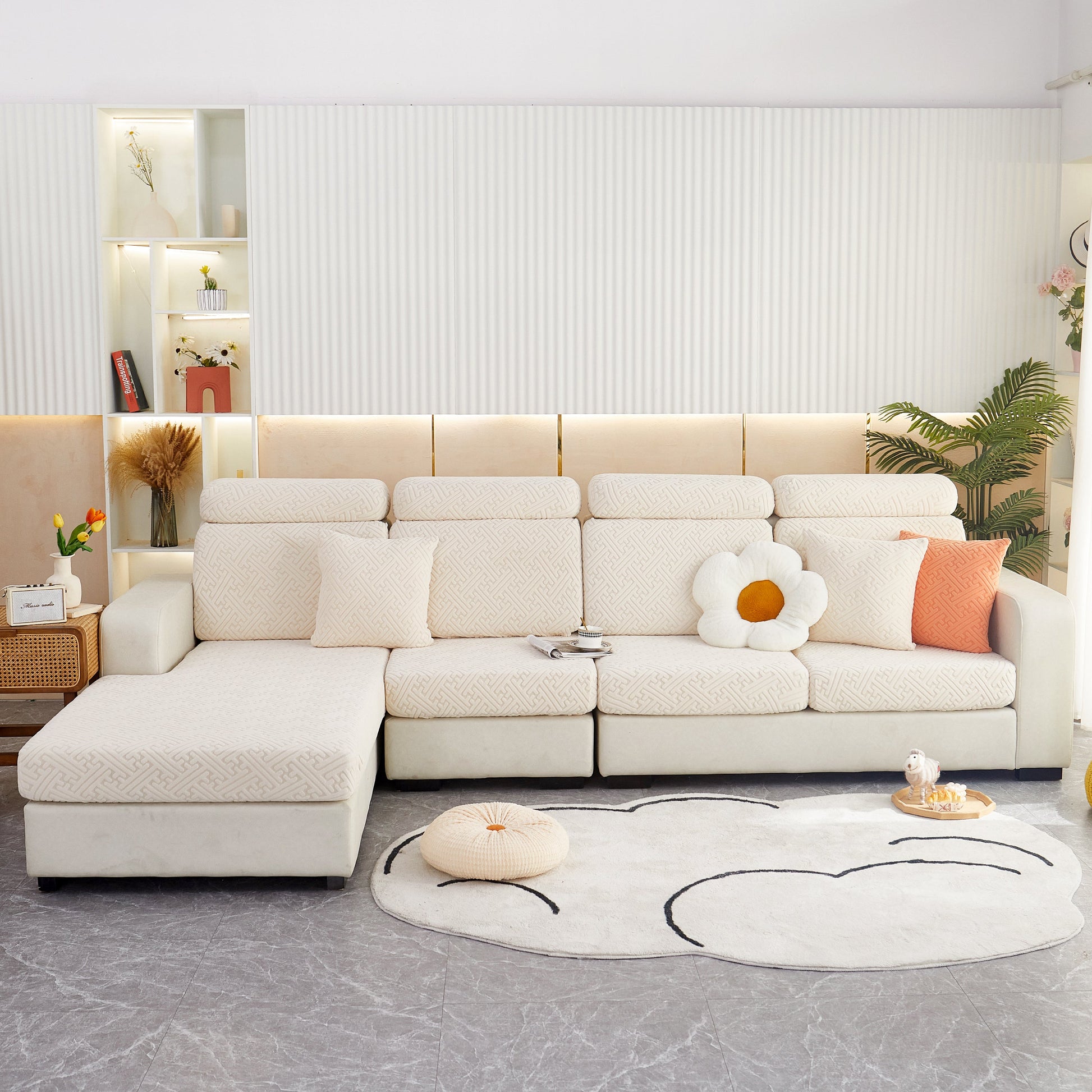 Modern living room featuring a cozy white sectional sofa with decorative pillows and a stylish carpet
