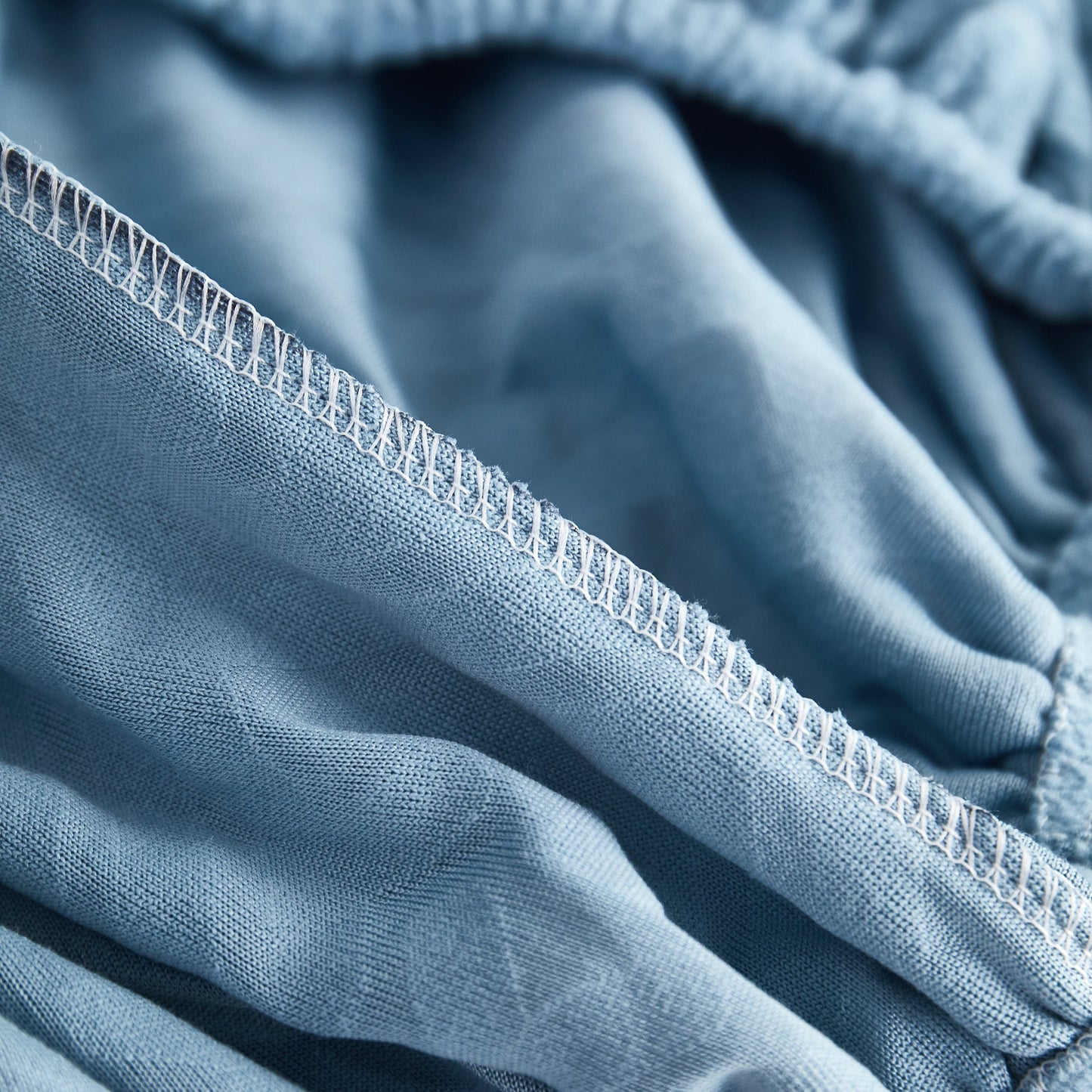 Close-up of Polar Fleece Couch Cushion Covers showcasing stretch and elastic fit for furniture protection.