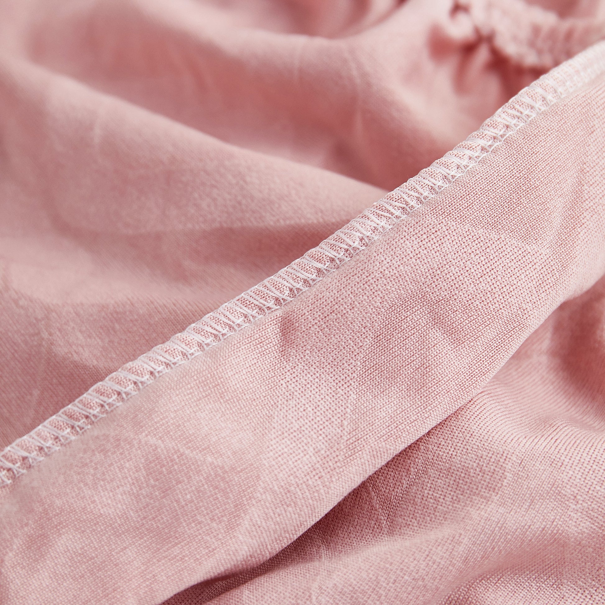 Close-up of Stretch Couch Seat Cushion Covers, Sofa Slipcover Sofa Cover Soft Flexibility with Elastic Bottom in pink fabric.