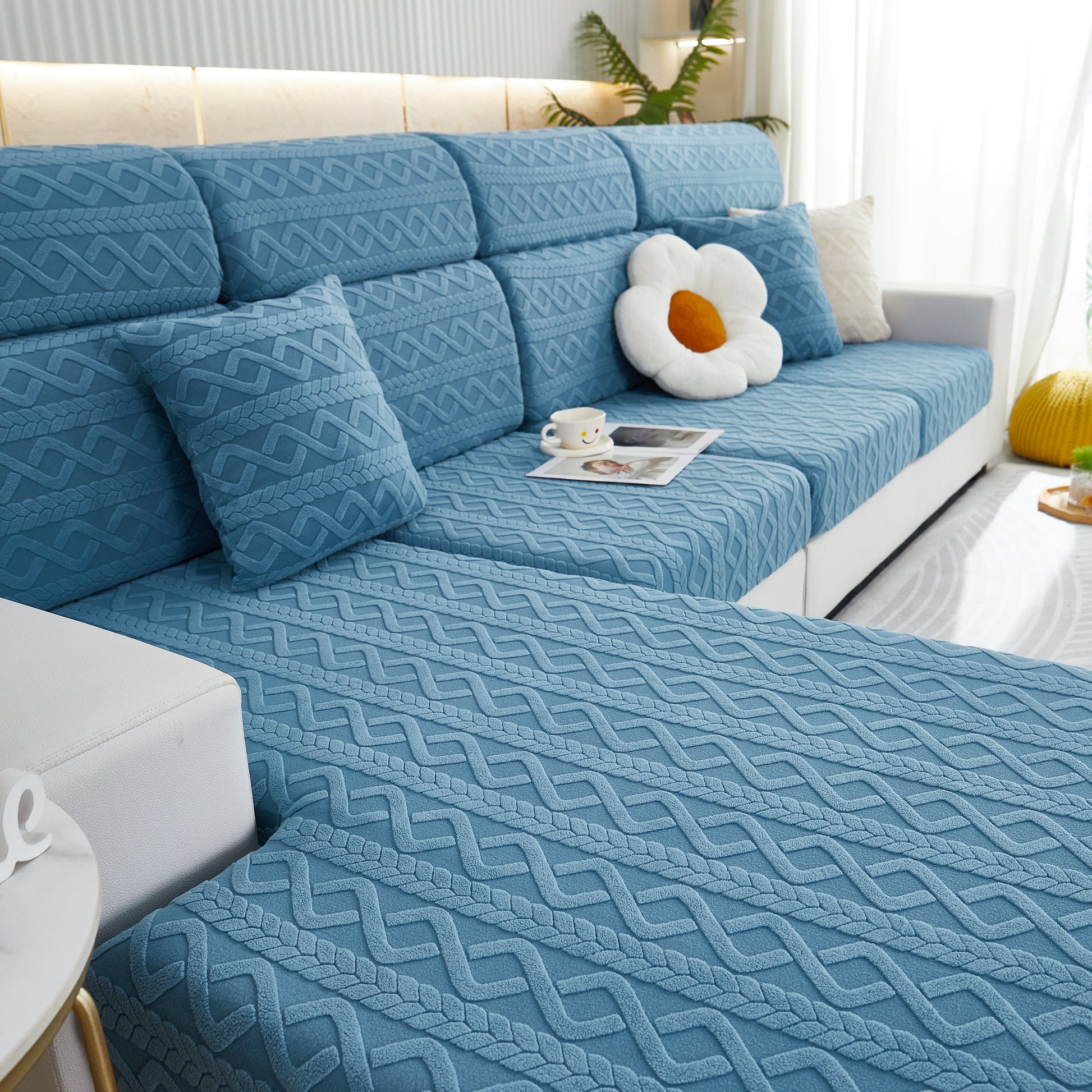 Blue fabric-covered sofa with patterned cushions featuring a Stretch Couch Seat Cushion Covers, Sofa Slipcover Sofa Cover Soft Flexibility with Elastic Bottom.