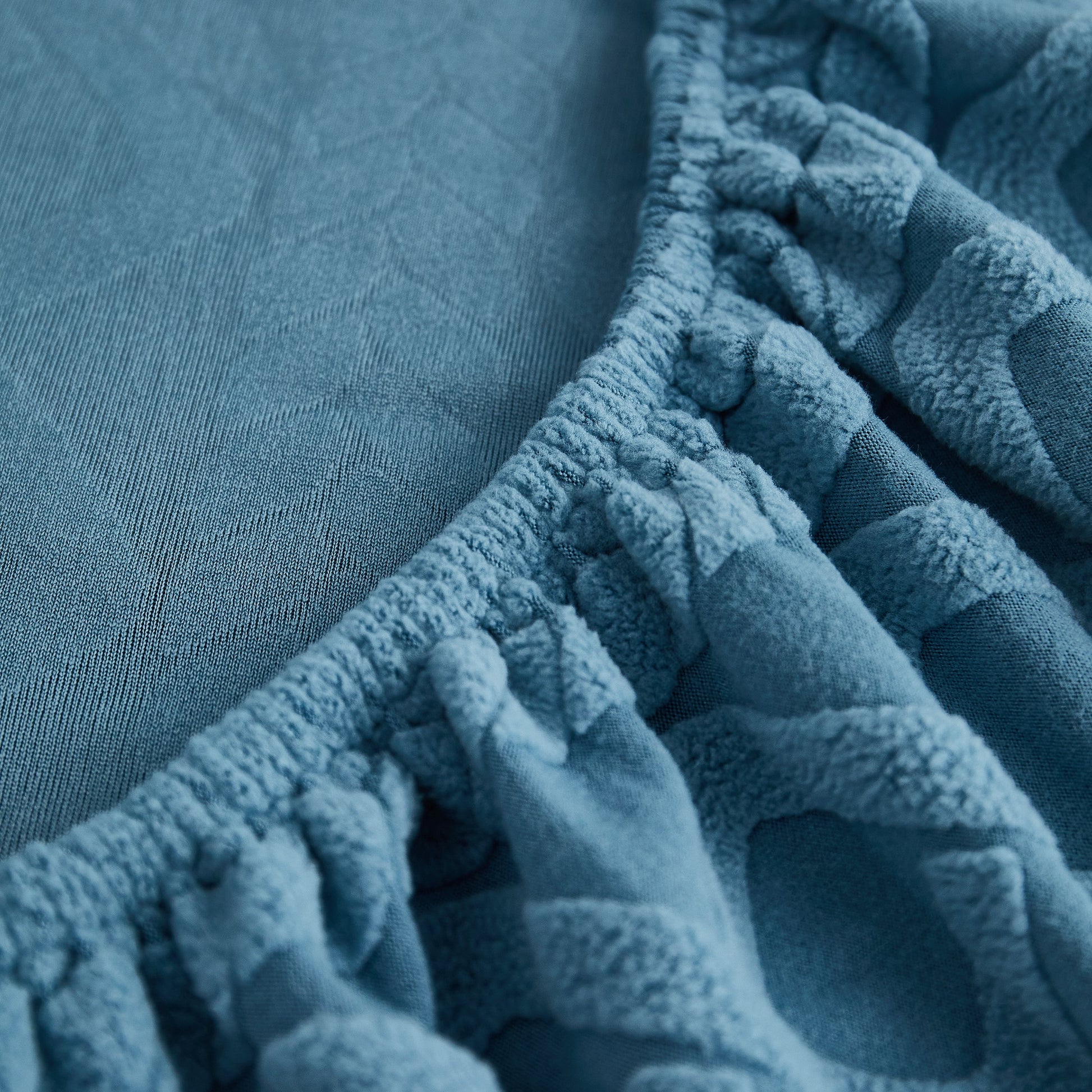 Close-up of Stretch Couch Seat Cushion Covers, Sofa Slipcover Sofa Cover Soft Flexibility with Elastic Bottom in blue fabric.