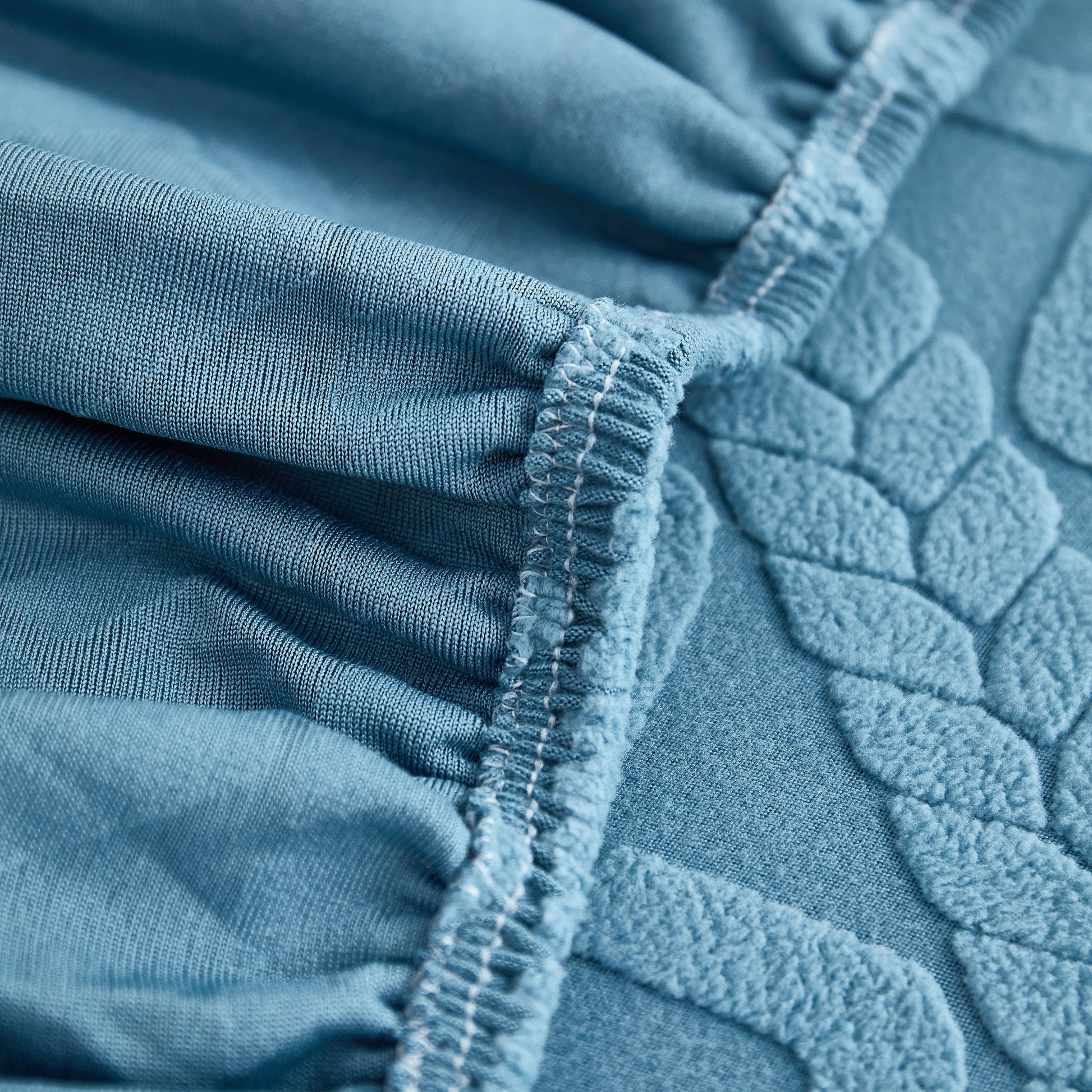 Close-up of Stretch Couch Seat Cushion Covers, Sofa Slipcover Sofa Cover Soft Flexibility with Elastic Bottom in blue fabric.