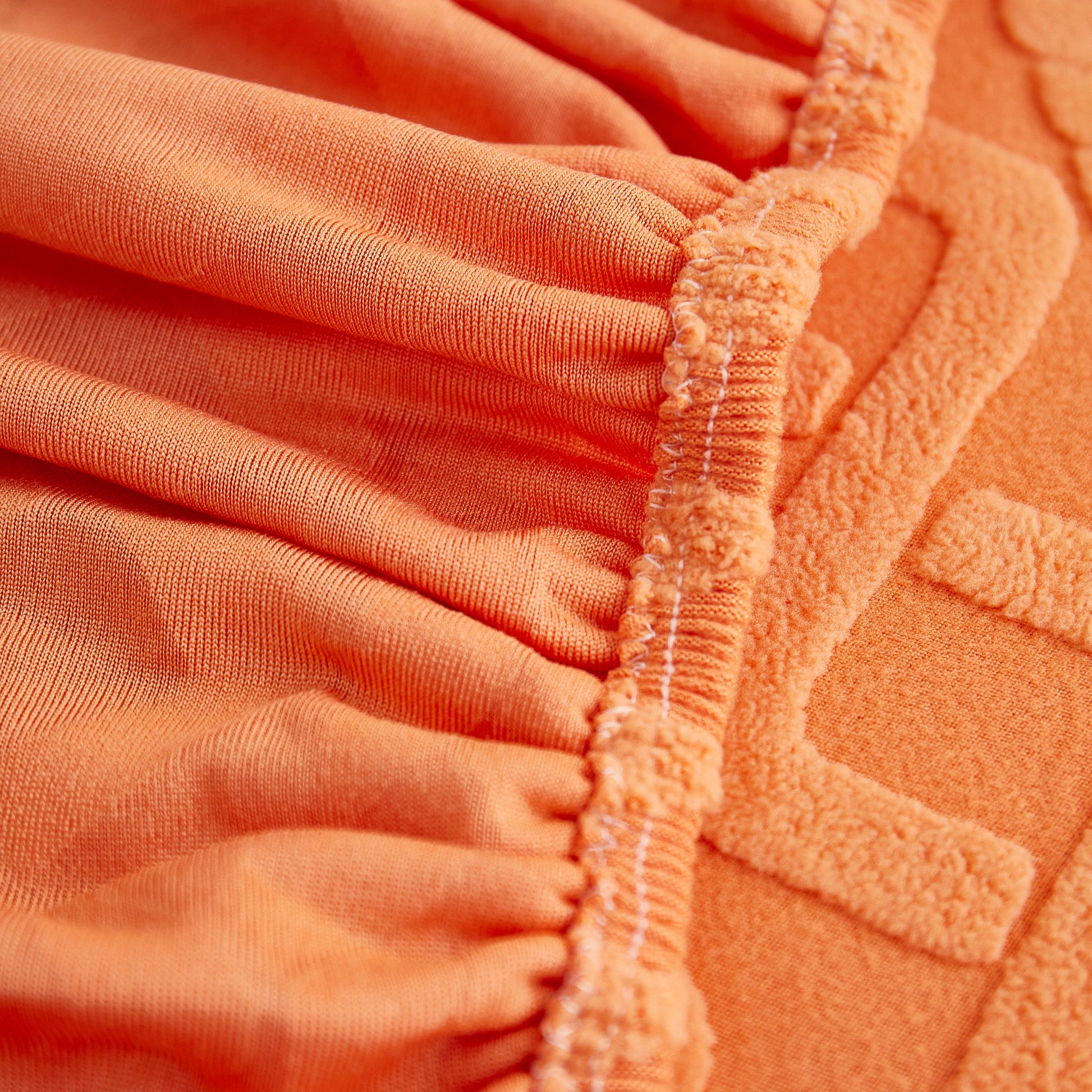 Close-up of orange Stretch Couch Seat Cushion Covers, Sofa Slipcover Sofa Cover Soft Flexibility with Elastic Bottom fabric and texture