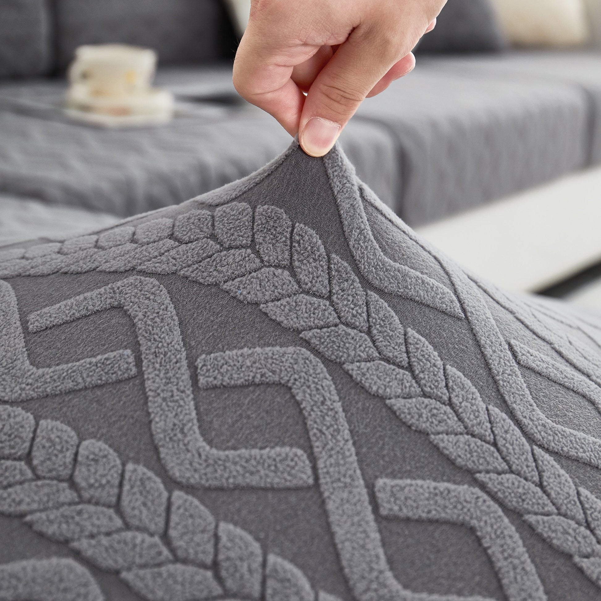 Close-up of a textured grey Stretch Couch Seat Cushion Cover with Elastic Bottom showcasing its flexibility and design.