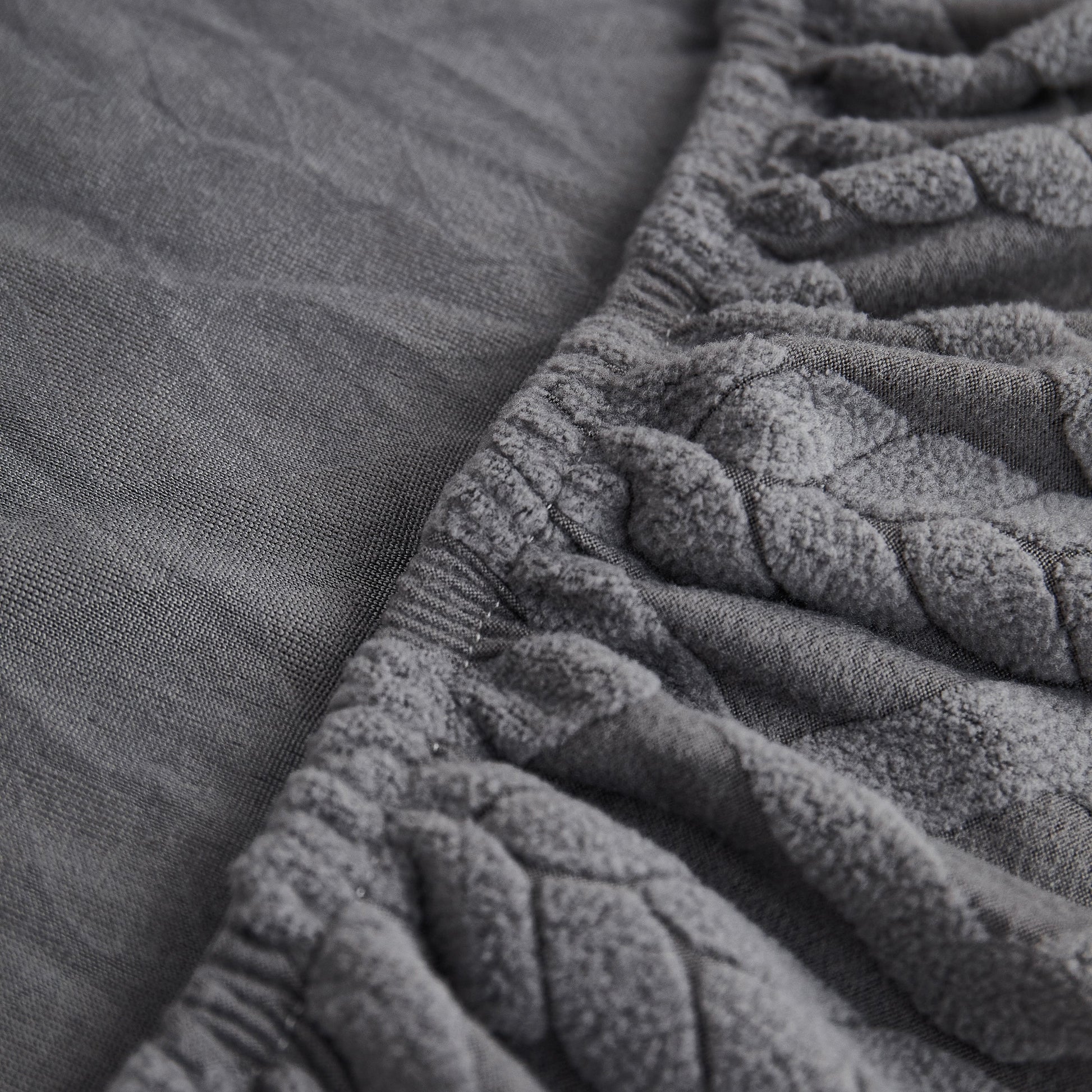 Close-up of Stretch Couch Seat Cushion Covers, Sofa Slipcover with Soft Elastic Bottom in grey fabric