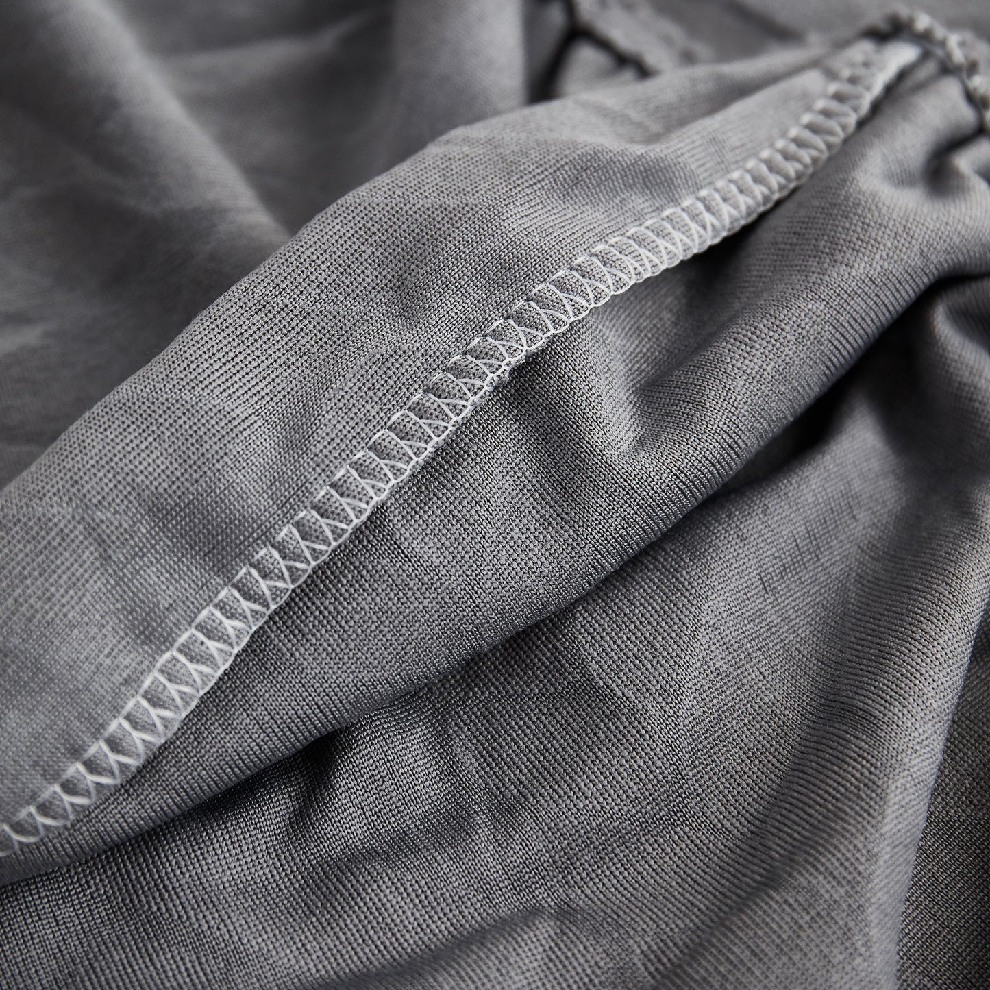 Close-up of Stretch Couch Seat Cushion Covers, Sofa Slipcover Sofa Cover Soft Flexibility with Elastic Bottom in gray fabric.