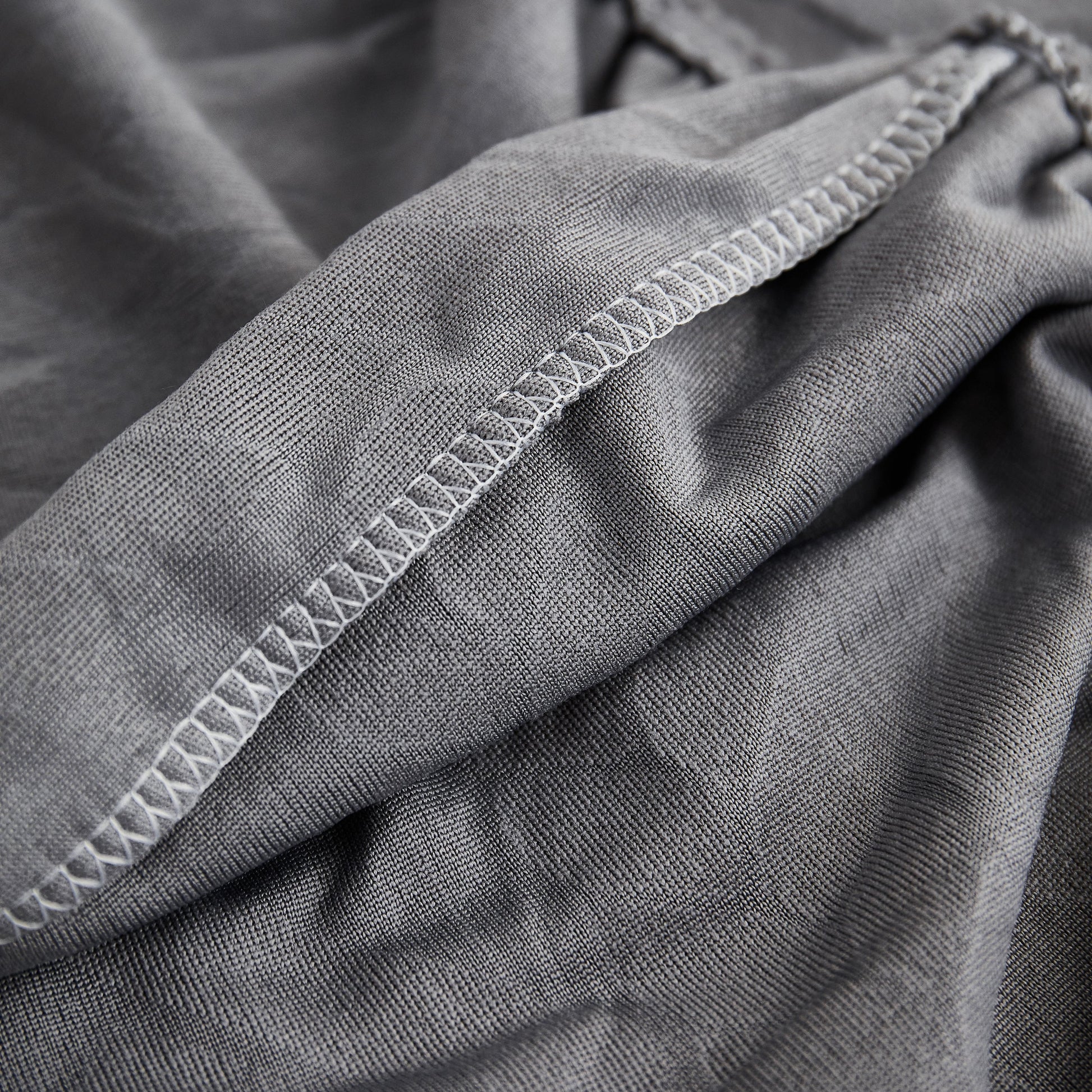 Close-up of Stretch Couch Seat Cushion Covers, Sofa Slipcover Sofa Cover Soft Flexibility with Elastic Bottom in gray fabric.