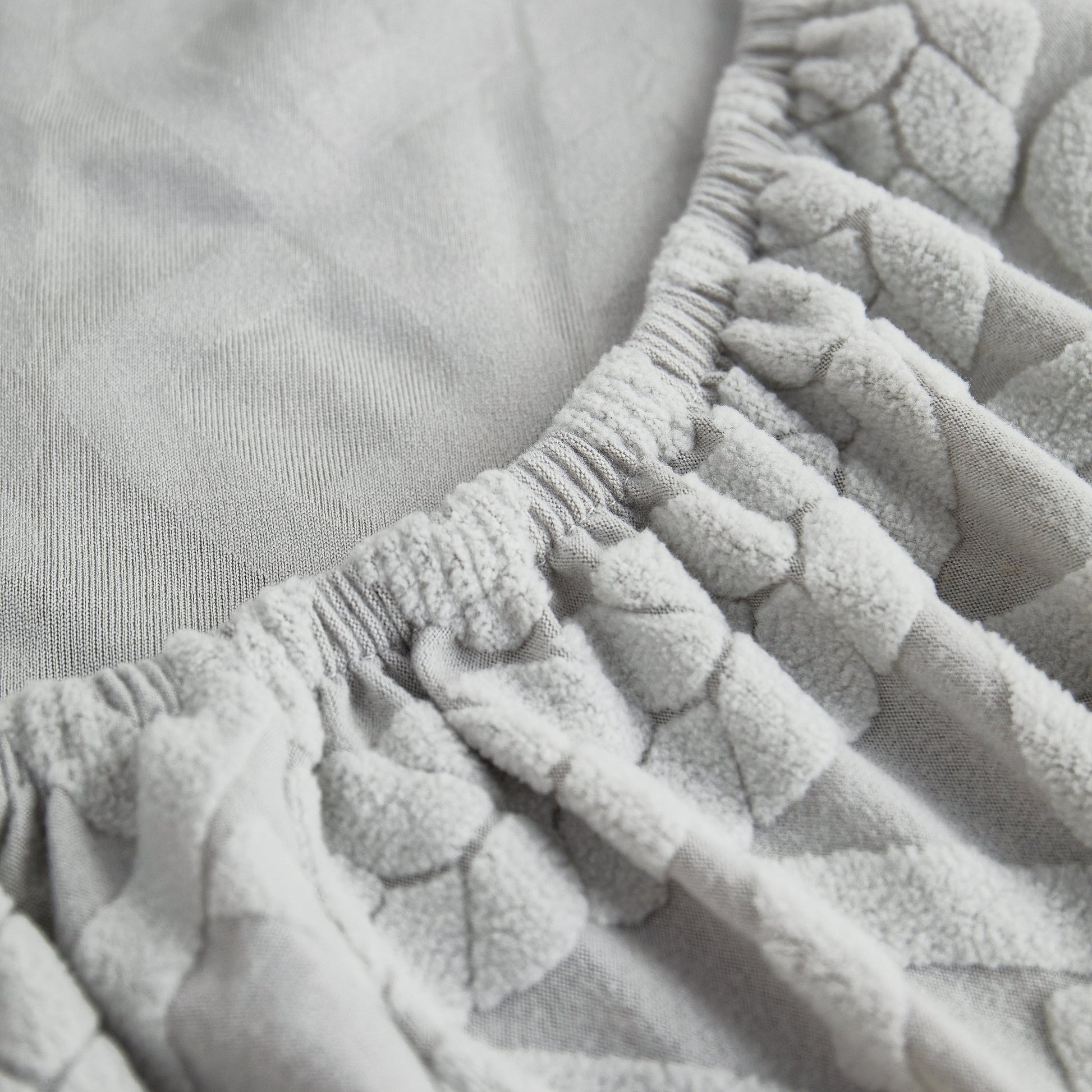Close-up of Stretch Couch Seat Cushion Covers, Sofa Slipcover Sofa Cover Soft Flexibility with Elastic Bottom in light grey fabric.