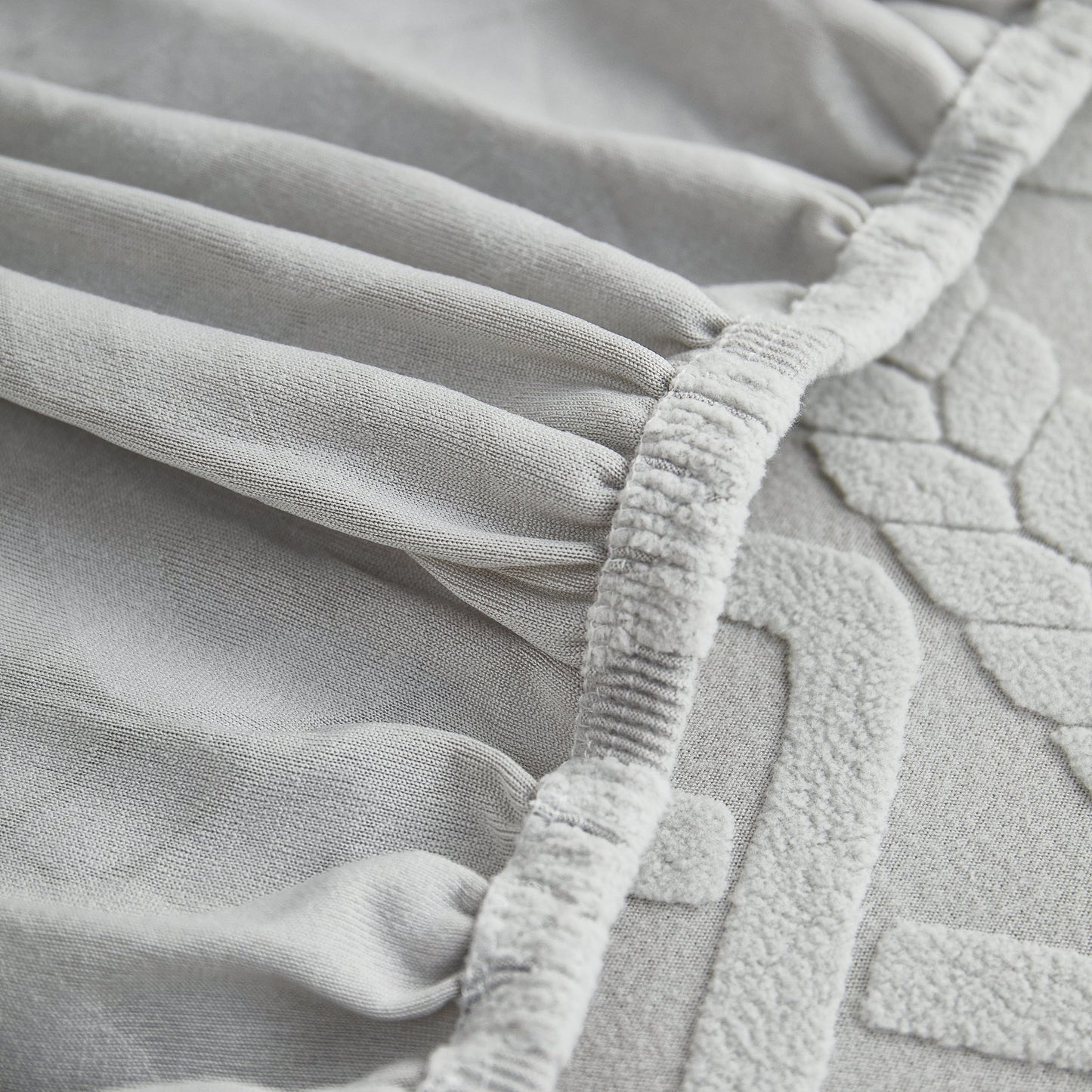 Close-up of Stretch Couch Seat Cushion Covers, Sofa Slipcover Sofa Cover Soft Flexibility with Elastic Bottom detail in grey fabric.
