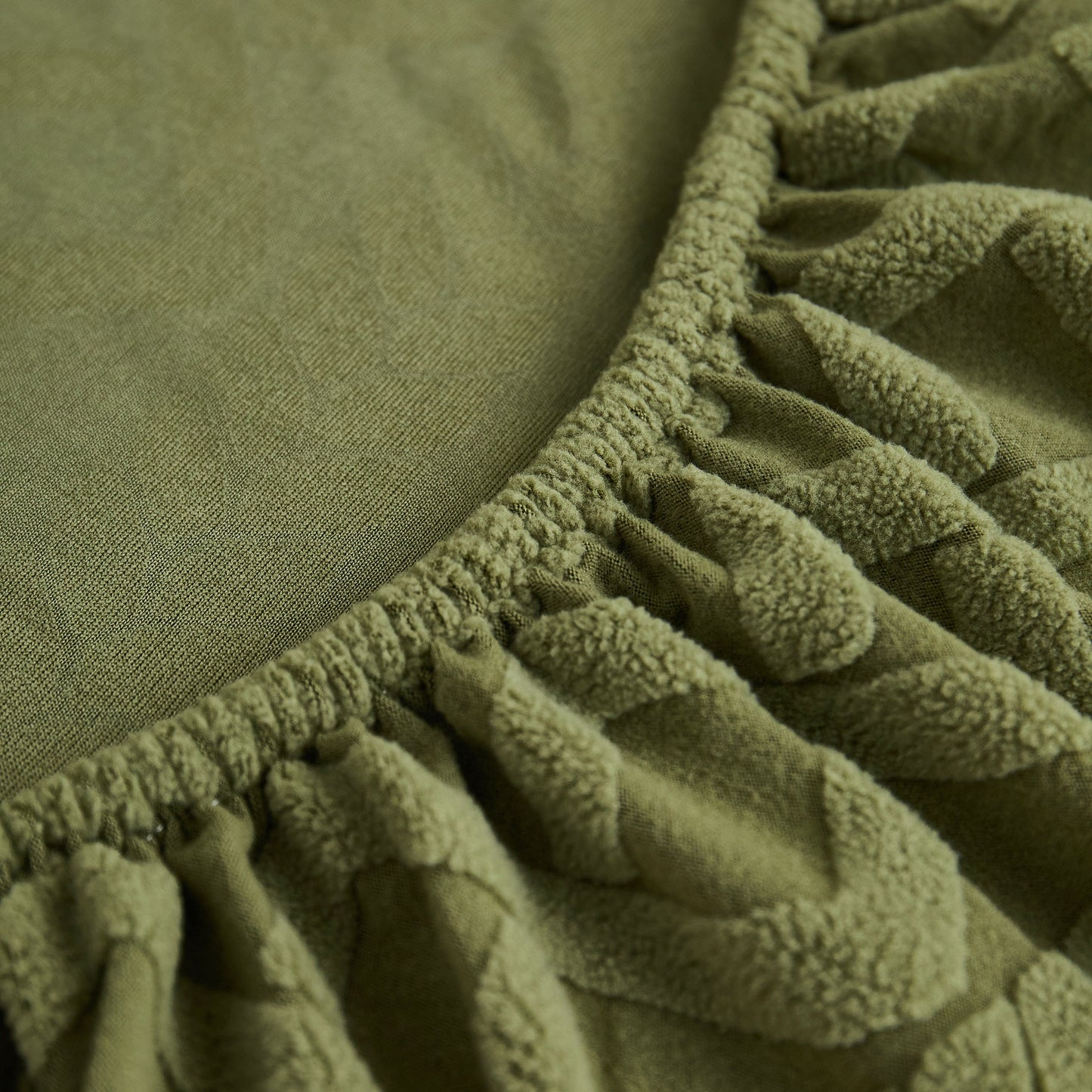 High-quality green Stretch Couch Seat Cushion Covers, Sofa Slipcover showing soft flexibility with elastic bottom detail