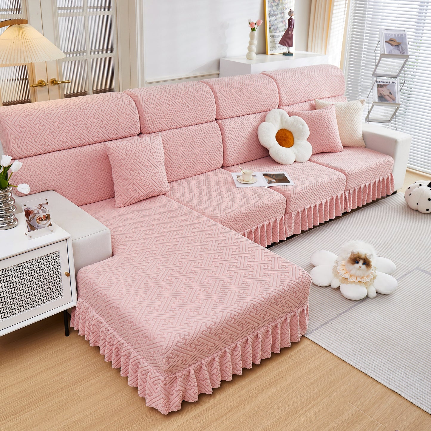 Pink stretch sofa covers with skirt for couch seat and cushion, chaise, sectional, 1/2/3/4 seater sofas in a living room setting.