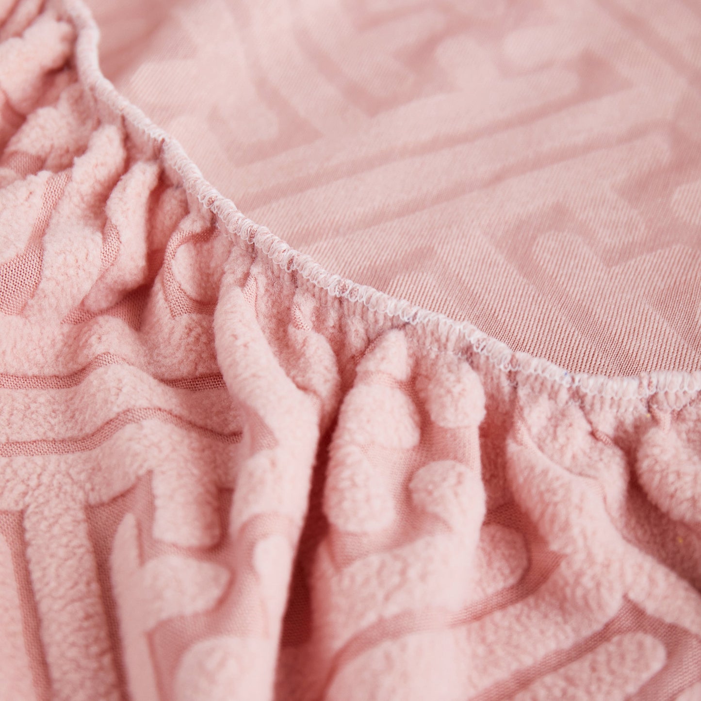 Close-up of pink Stretch Sofa Covers with Skirt for Couch Seat and Cushion, featuring detailed fabric texture for protection and style.