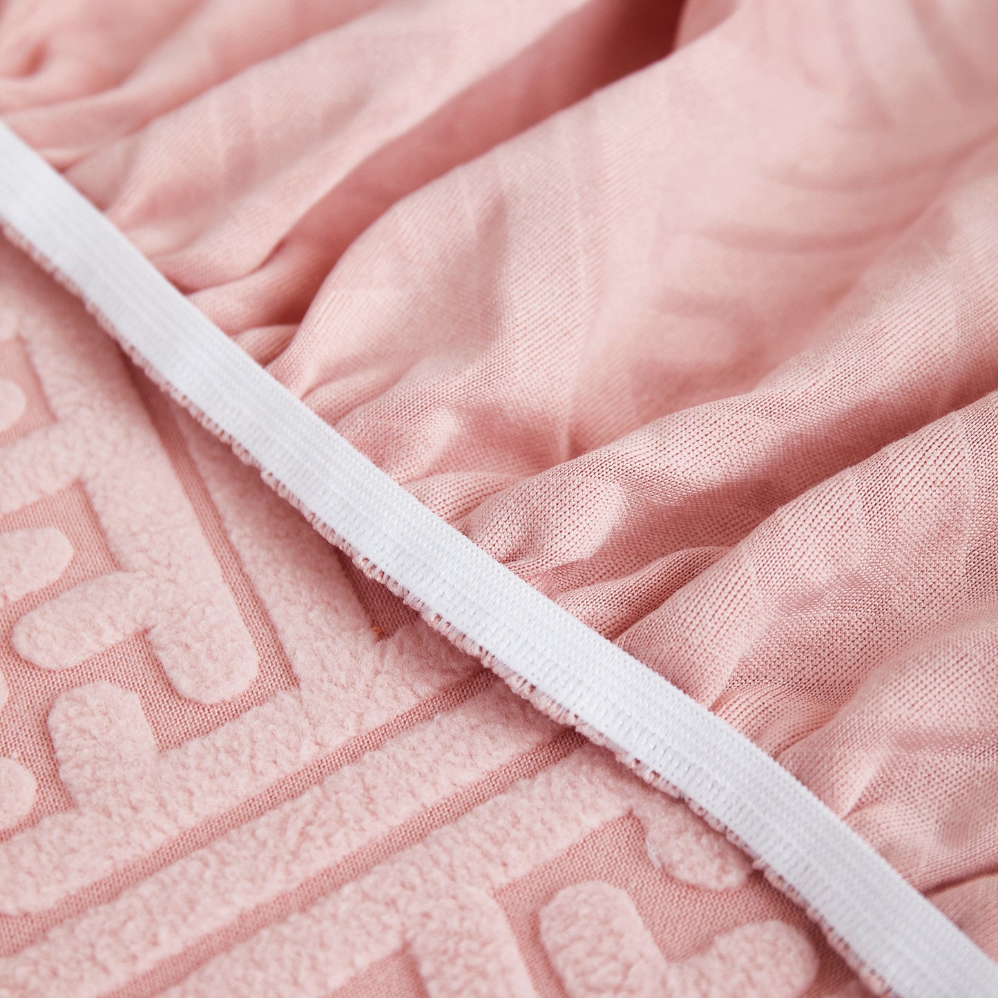 Close-up of pink Stretch Sofa Covers with Skirt for Couch Seat and Cushion, Chaise, Sectional, 1/2/3/4 Seater Sofas fabric detail