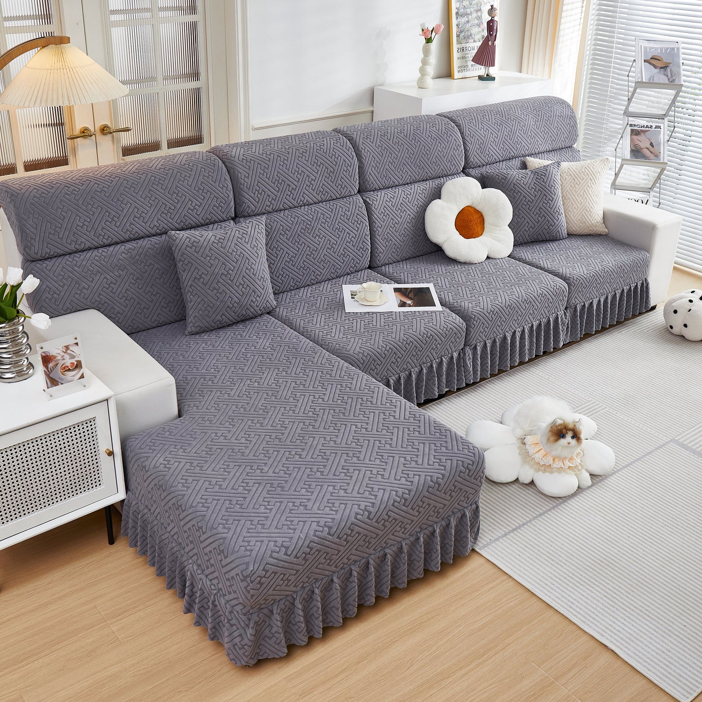 Stretch Sofa Covers with Skirt for Couch Seat and Cushion, Chaise, Sectional, 1/2/3/4 Seater Sofas in gray on a living room couch.