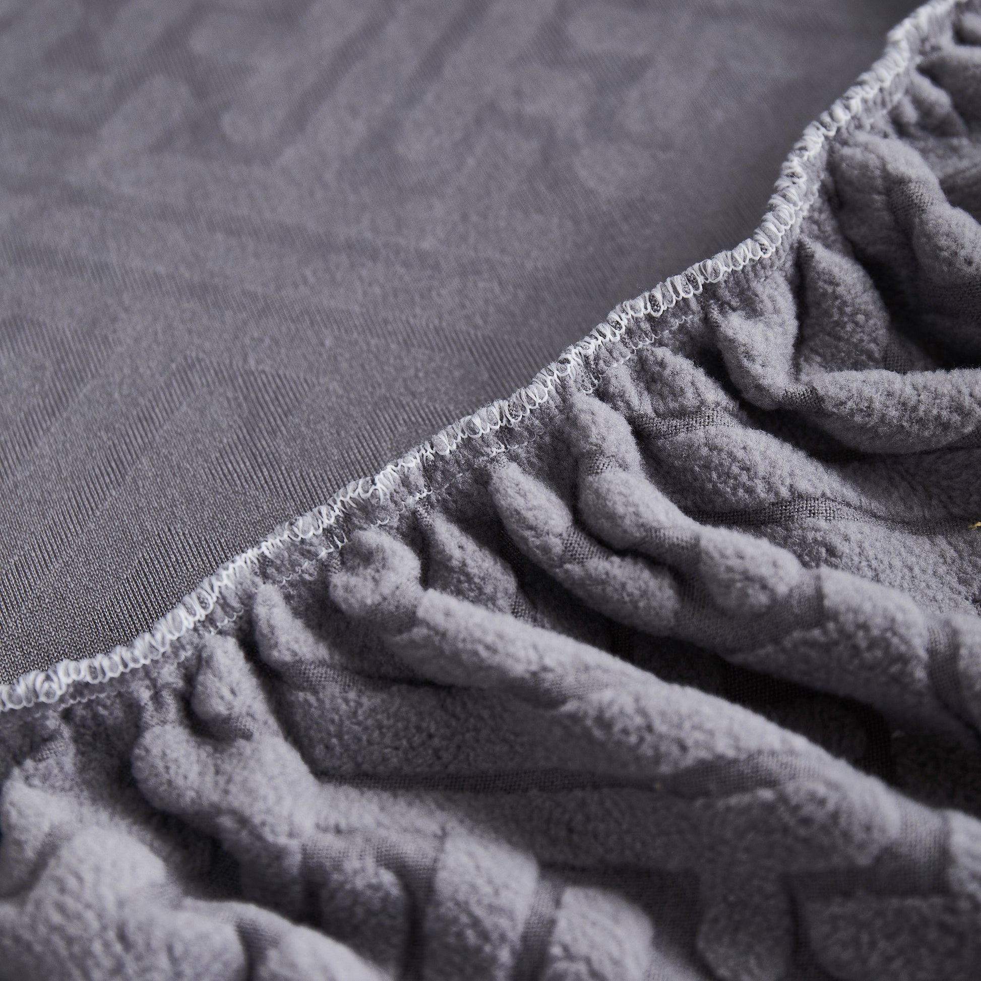 Close-up of Stretch Sofa Covers with Skirt for Couch Seat and Cushion, Chaise, Sectional, 1/2/3/4 Seater Sofas fabric texture.