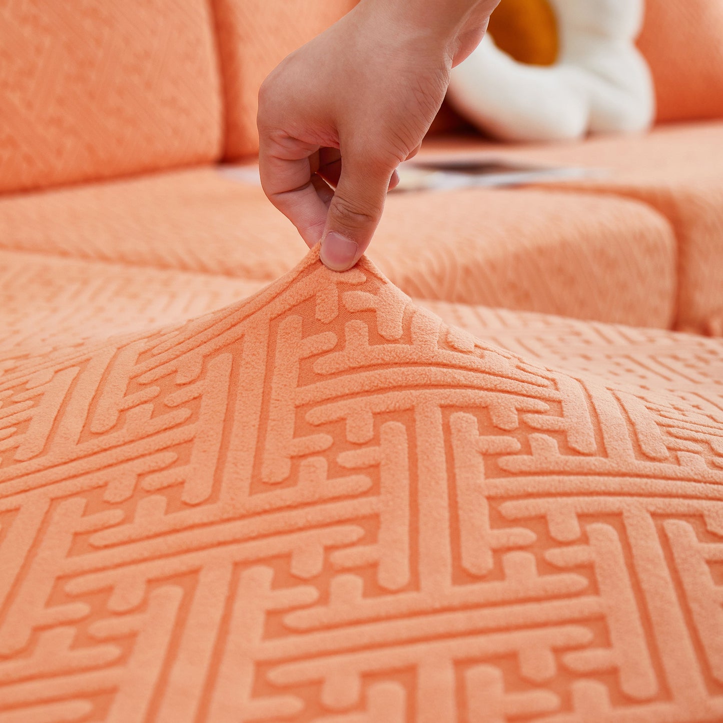 Close-up of orange textured fabric on Stretch Sofa Covers with Skirt for Couch Seat and Cushion, Chaise, Sectional, 1/2/3/4 Seater Sofas.