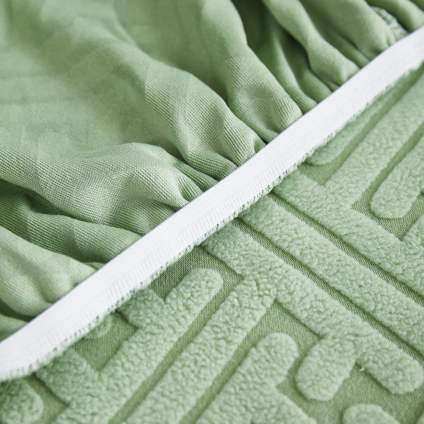Close-up of green Stretch Sofa Covers with Skirt for Couch Seat and Cushion, Chaise, Sectional, 1/2/3/4 Seater Sofas