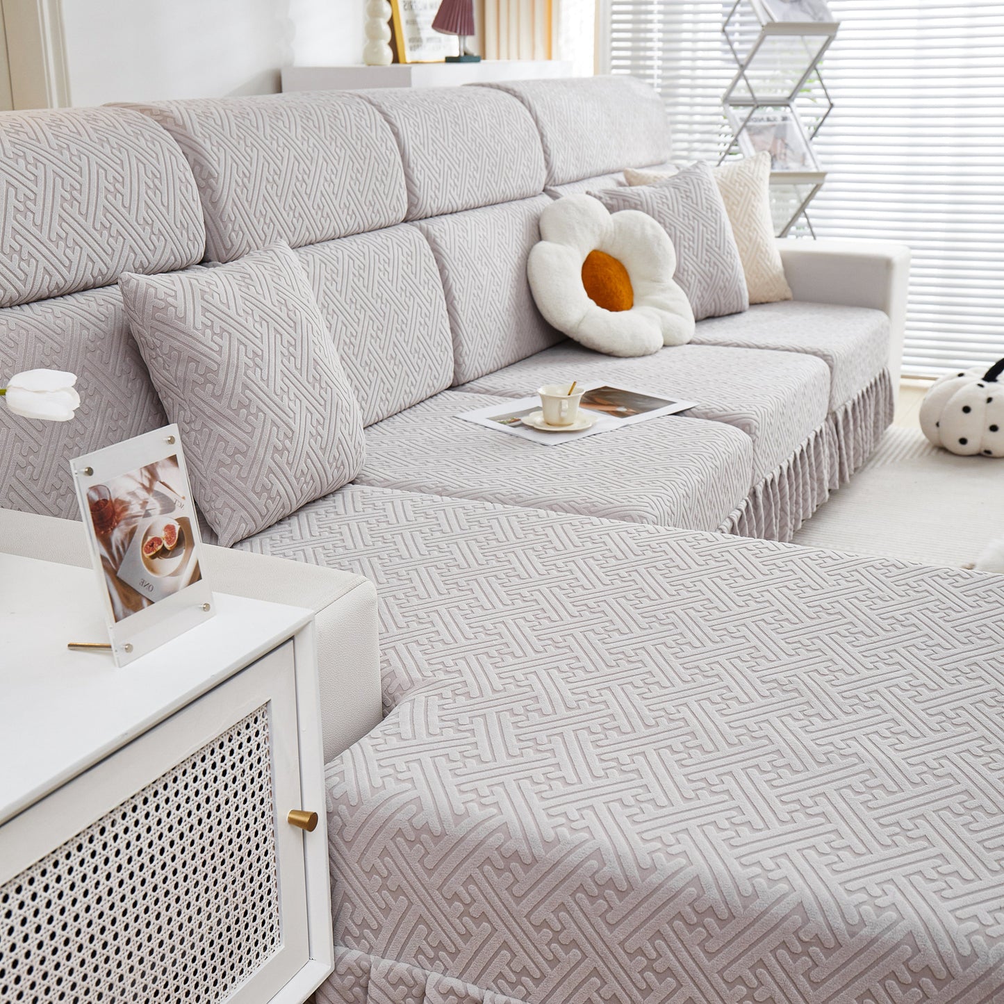 Living room with a sofa covered by Stretch Sofa Covers with Skirt for Couch Seat and Cushion, Chaise, Sectional, 1/2/3/4 Seater Sofas.