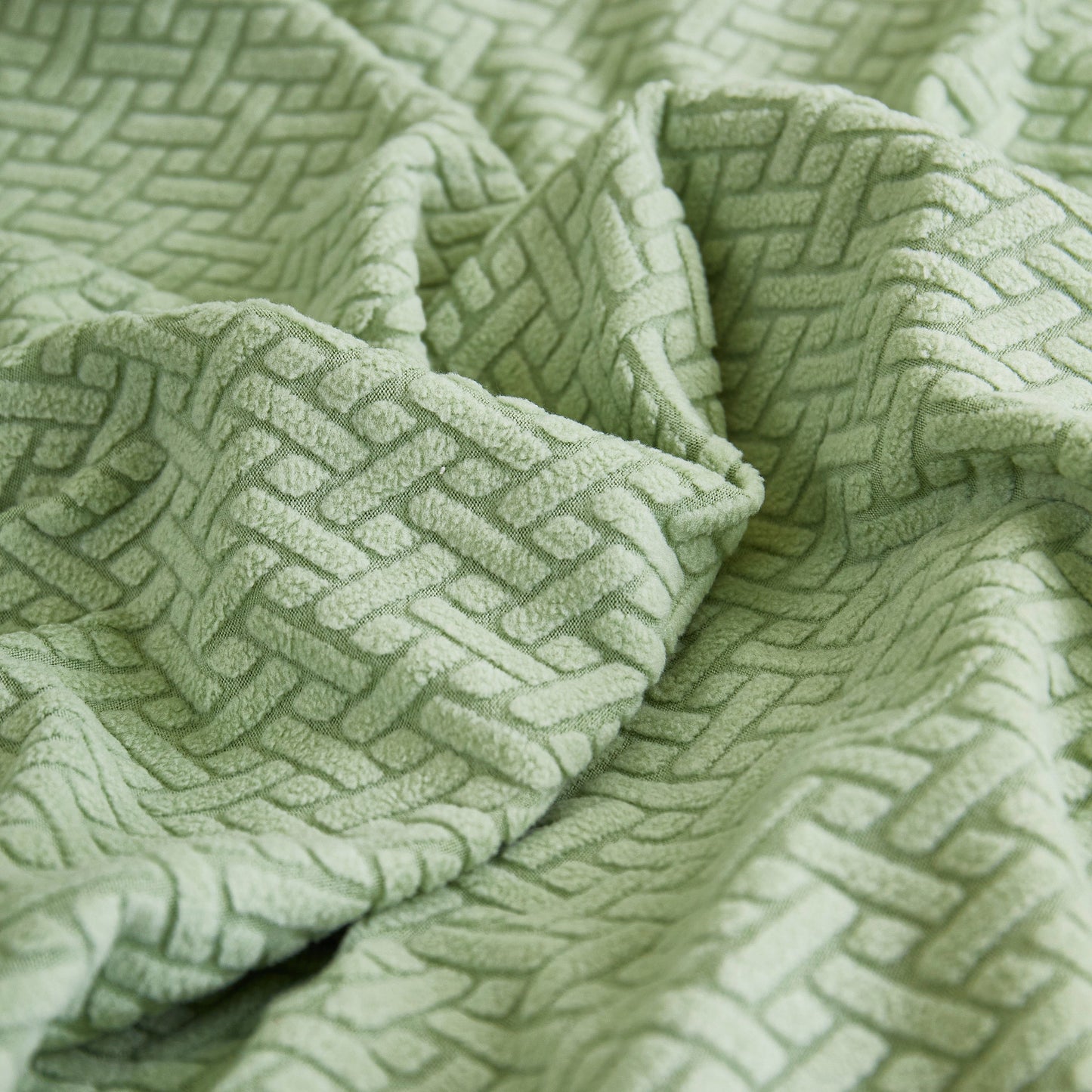 Close-up of textured green fabric for Tailored Sofa Cushion Covers Stretch Couch Seat Covers with Skirt for Sectional Sofas.