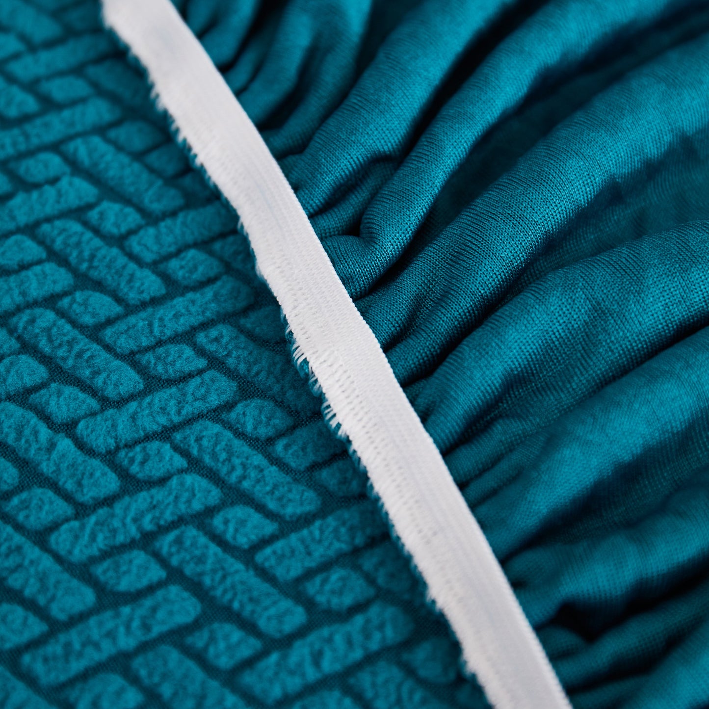 Close-up of Tailored Sofa Cushion Covers Stretch Couch Seat Covers with Skirt for Sectional Sofas in turquoise fabric texture.