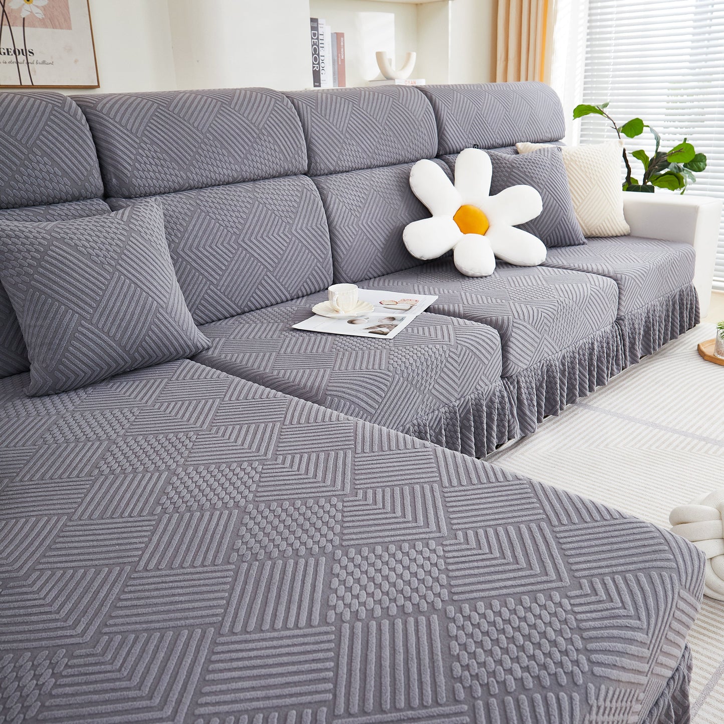 Stretch Sofa Covers for Couch Seats and Cushions on a stylish L-seater sofa with a decorative flower cushion in a modern living room