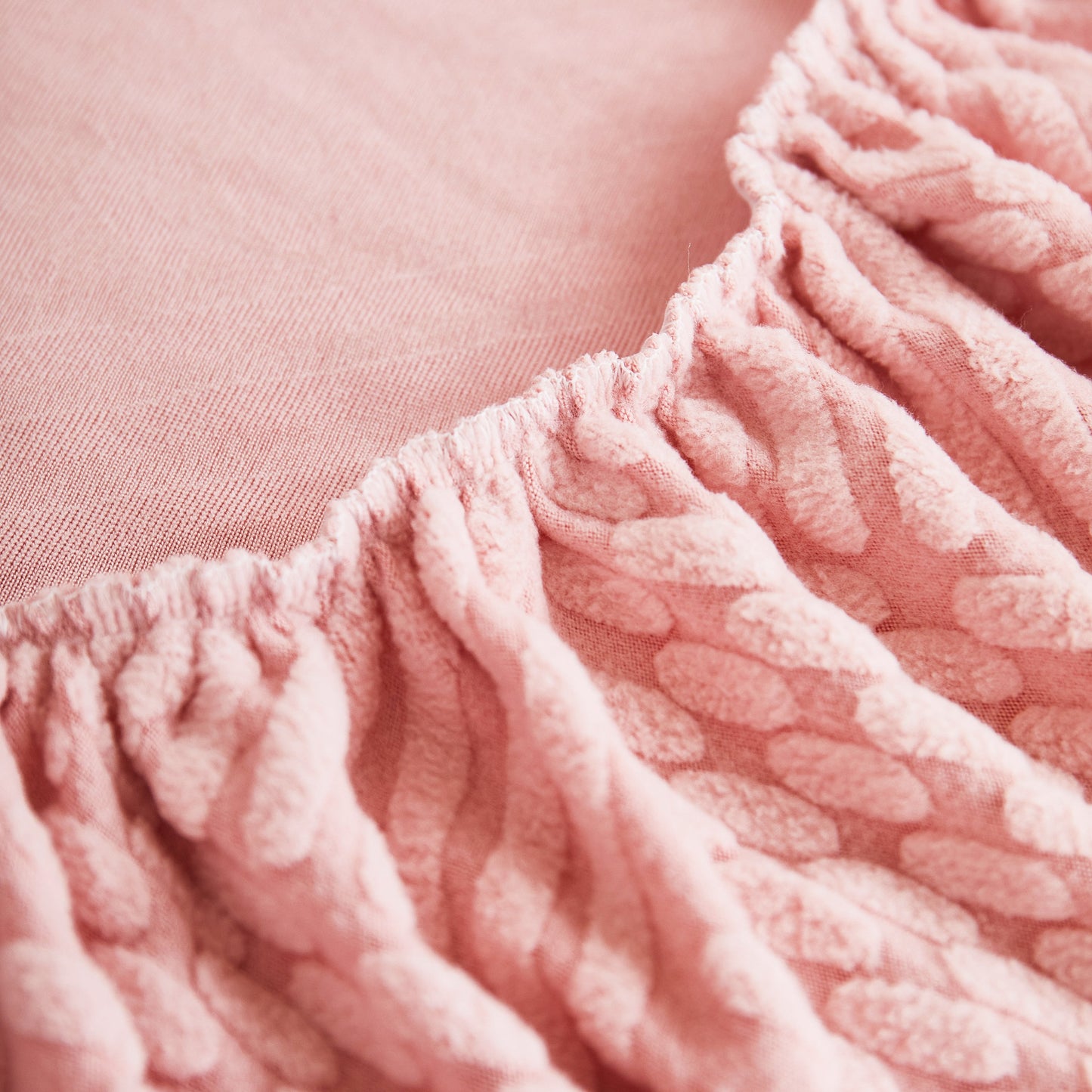 Close-up of pink textured fabric for Stretch Sofa Covers for Couch Seats and Cushions, Suitable for 1/2/3/4/L Seater Sofas and Couches.