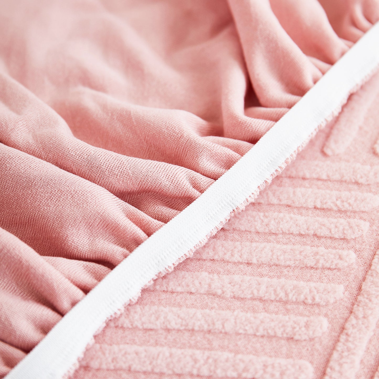 Close-up of pink Stretch Sofa Covers for Couch Seats and Cushions, Suitable for 1/2/3/4/L Seater Sofas and Couches with elegant skirt detail