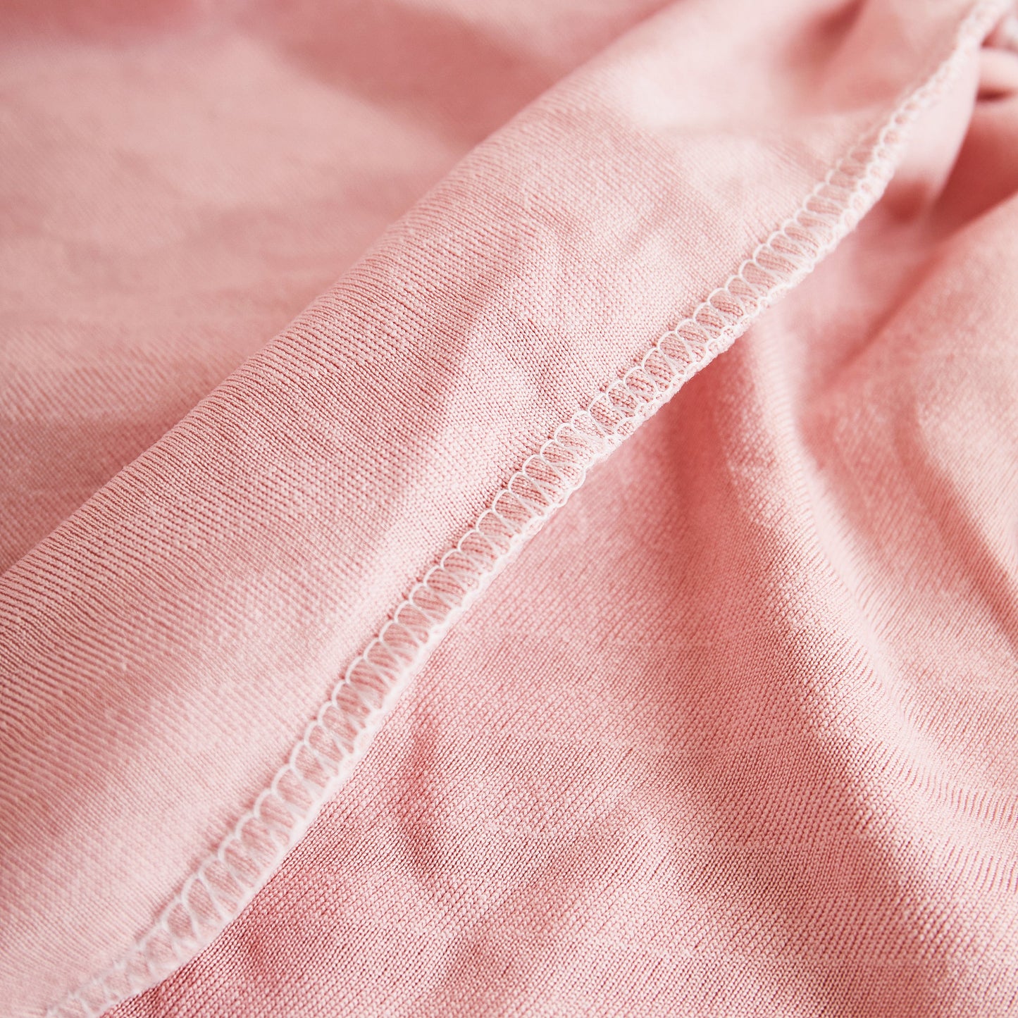 Close-up view of pink fabric texture, part of Stretch Sofa Covers for Couch Seats and Cushions, Suitable for 1/2/3/4/L Seater Sofas and Couches.