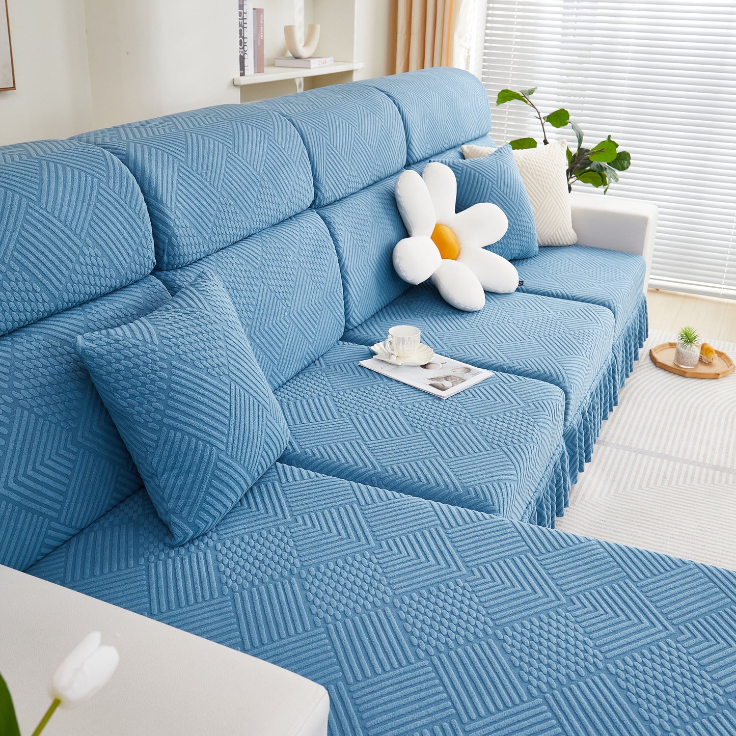 Blue stretch sofa covers for 1/2/3/4/L seater sofas and couches with stylish skirt, showcasing a modern and elegant living room setting.