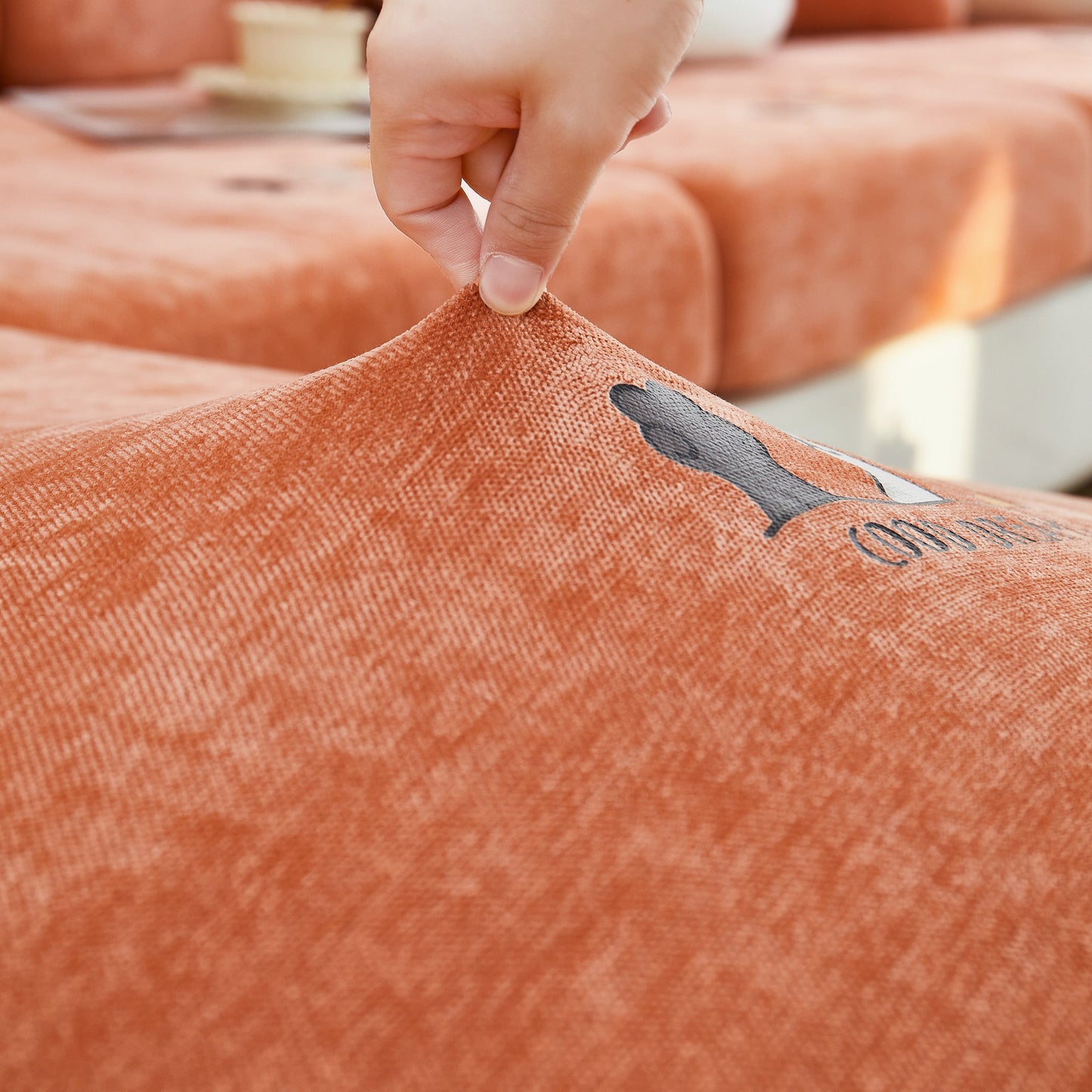 Hand demonstrating stretch of Super Stretch Seat Cushion/Couch Slipcover, Solid Couch Cushion Covers Washable Furniture Protector