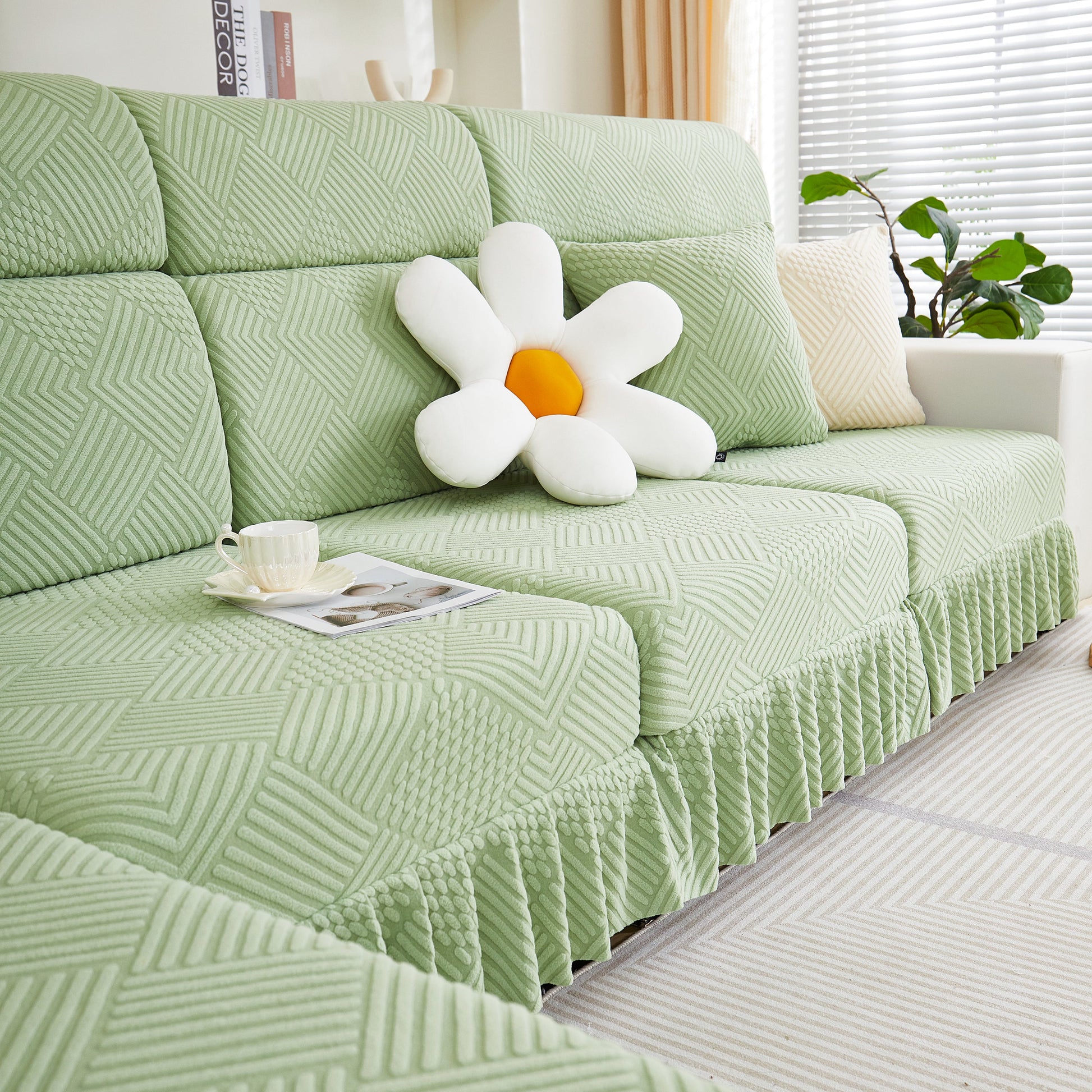 Stretch Sofa Covers for Couch Seats and Cushions, Suitable for 1/2/3/4/L Seater Sofas and Couches with a flower pillow on top.