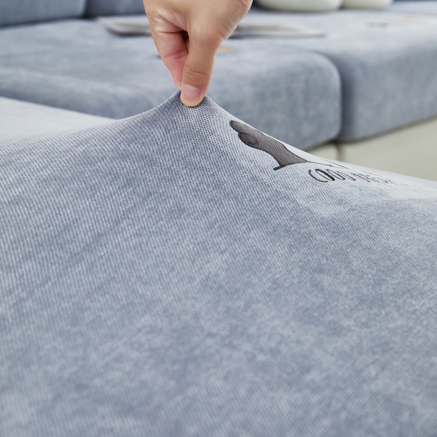 Person adjusting Super Stretch Seat Cushion/Couch Slipcover, Solid Couch Cushion Covers Washable Furniture Protector.