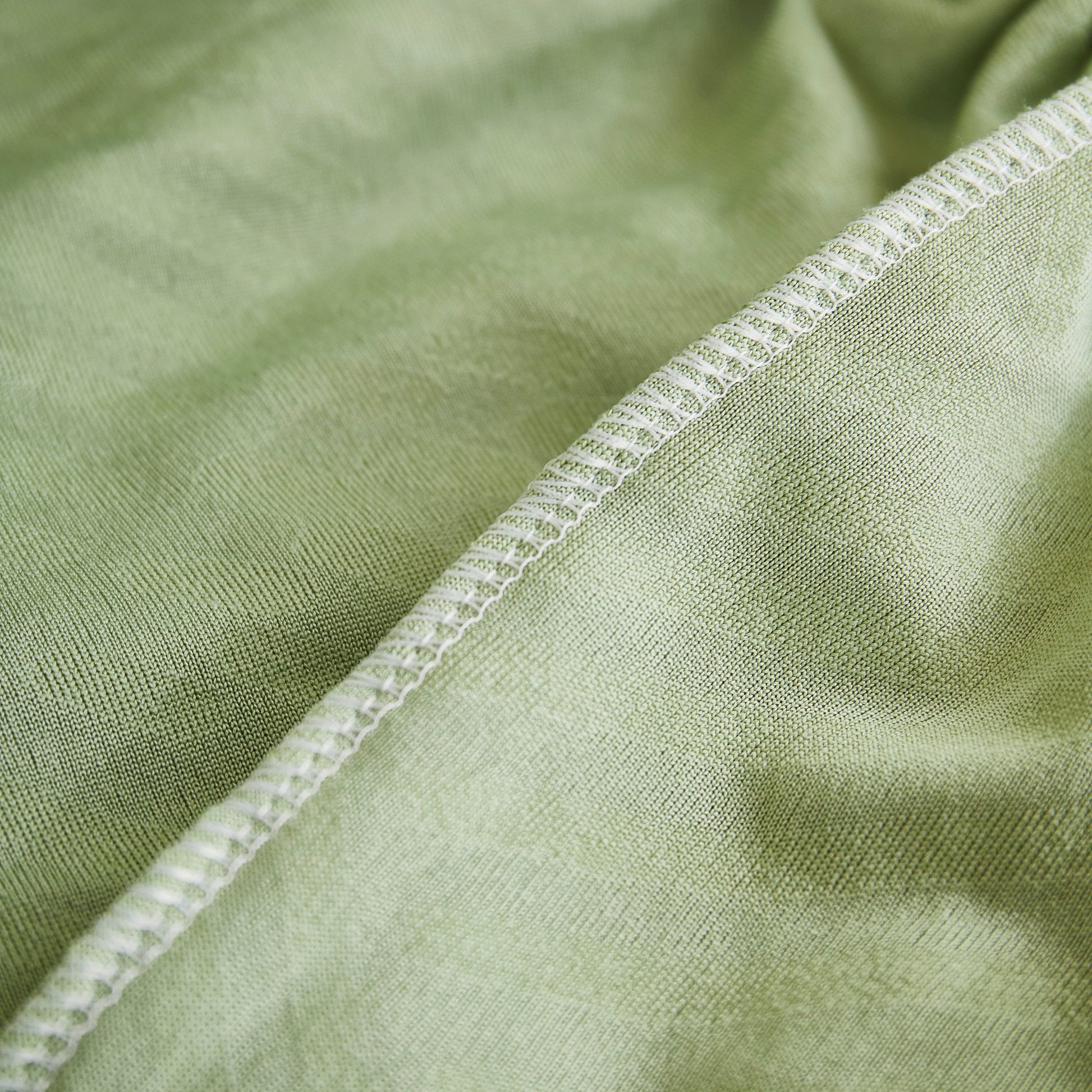 Close-up of green Stretch Sofa Covers for Couch Seats and Cushions, Suitable for 1/2/3/4/L Seater Sofas and Couches.