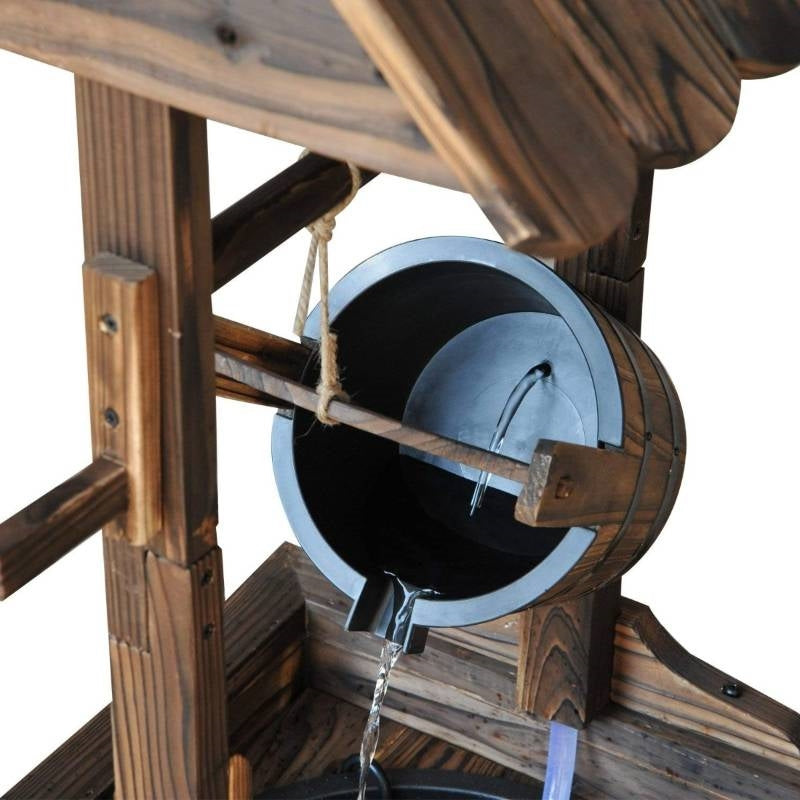 Close-up of Outdoor Garden Solid Wood Wishing Well Water Fountain with Bucket and Pump showing water flow from the bucket.